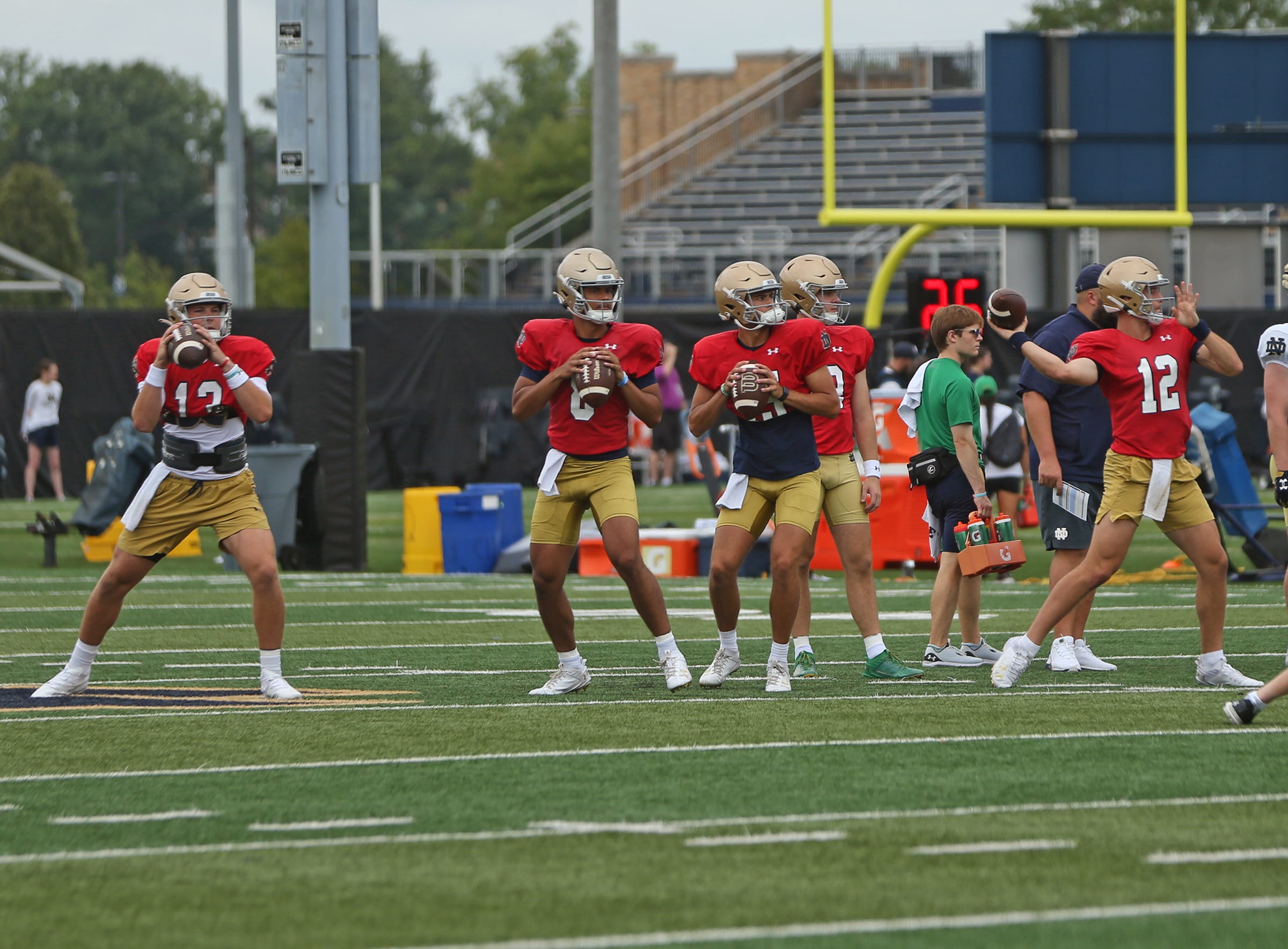 Notre Dame quarterbacks, from left, Riley Leonard, Kenny Minchey, Anthony Rezac and CJ Carr, throw passes in a drill during a practice Friday, August 2, 2024, at the Irish Athletics Center in South Bend.