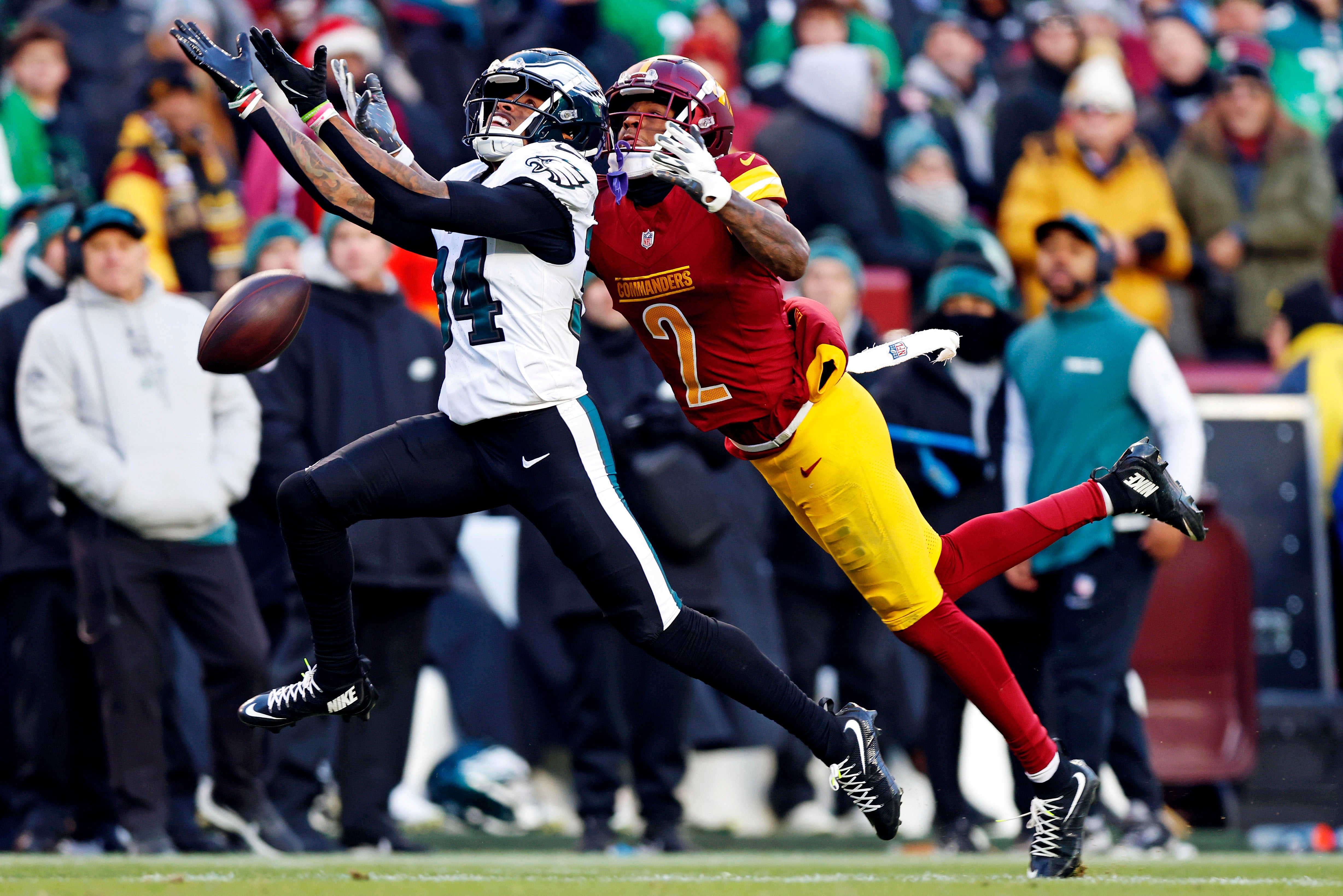 Dec 22, 2024; Landover, Maryland, USA; Philadelphia Eagles cornerback Isaiah Rodgers (34) breaks up a pass intended Washington Commanders wide receiver Dyami Brown (2) during the fourth quarter at Northwest Stadium.