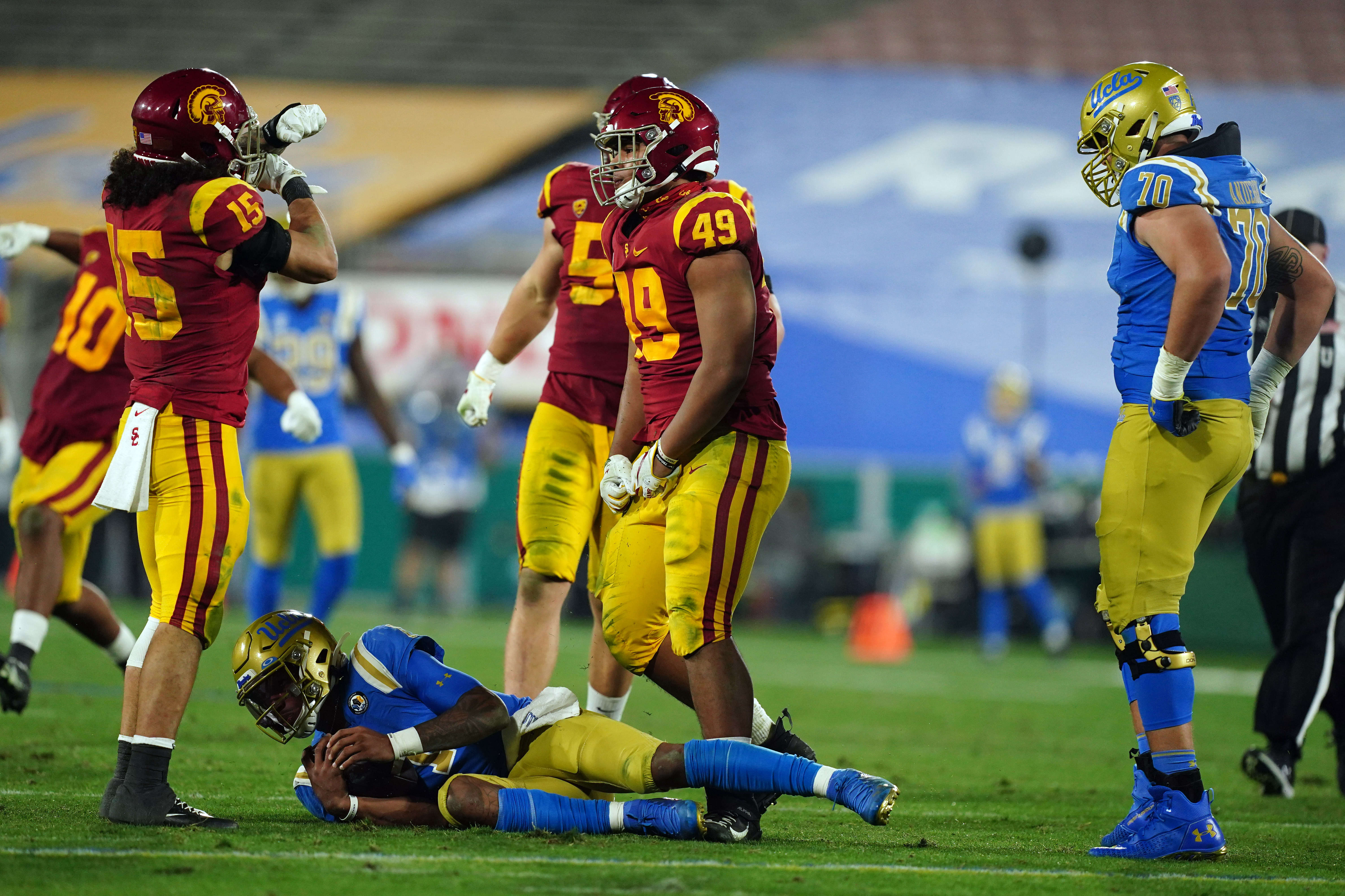 Southern California Trojans safety Talanoa Hufanga (15) and defensive lineman Tuli Tuipulotu (49) celebrate after a sack of UCLA Bruins quarterback Dorian Thompson-Robinson (1) as offensive lineman Alec Anderson (70) watches in the third quarterat Rose Bowl. USC defeated UCLA 43-38.