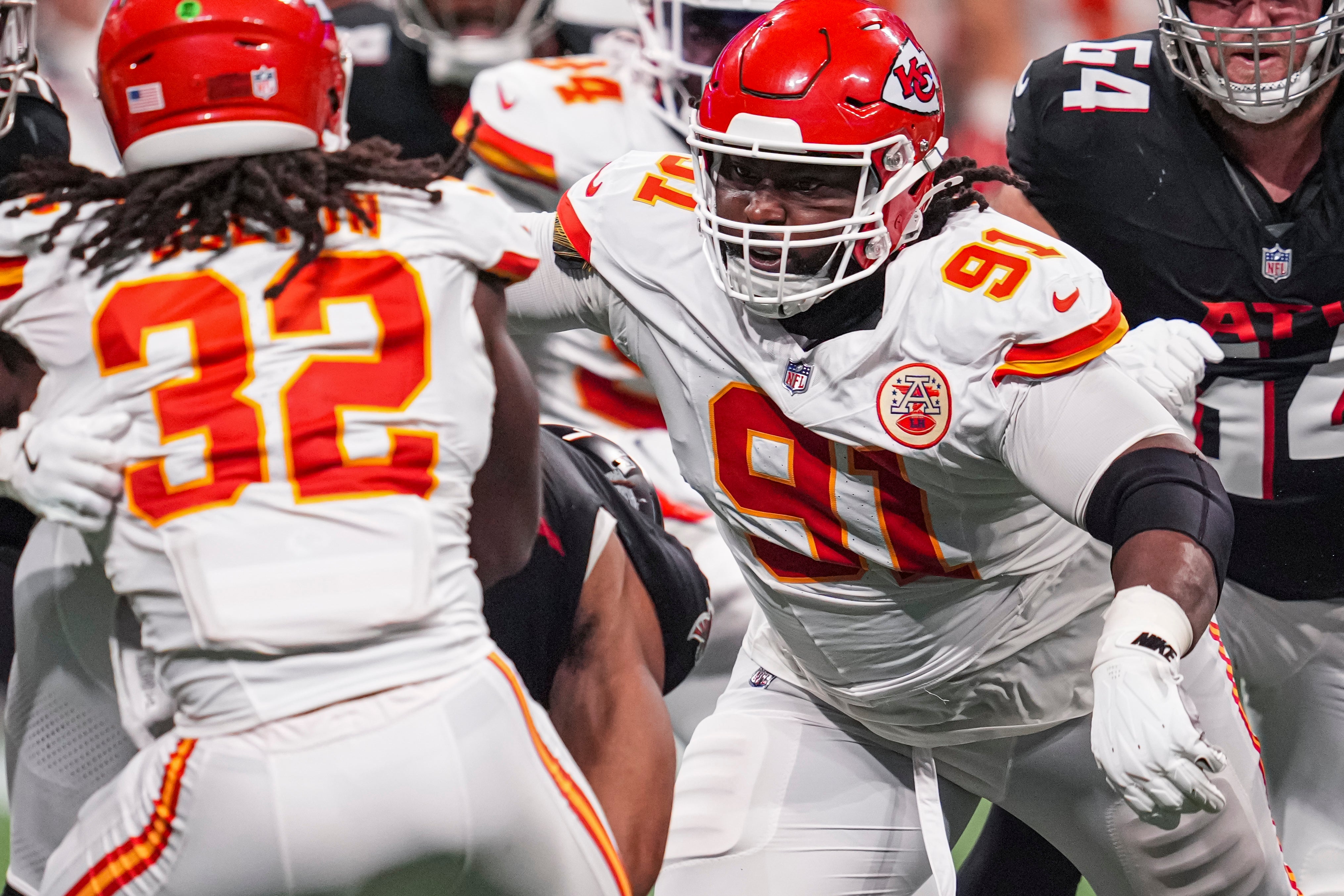Sep 22, 2024; Atlanta, Georgia, USA; Kansas City Chiefs defensive tackle Derrick Nnadi (91) looks to tackle Atlanta Falcons running back Bijan Robinson (7) during the second half at Mercedes-Benz Stadium.