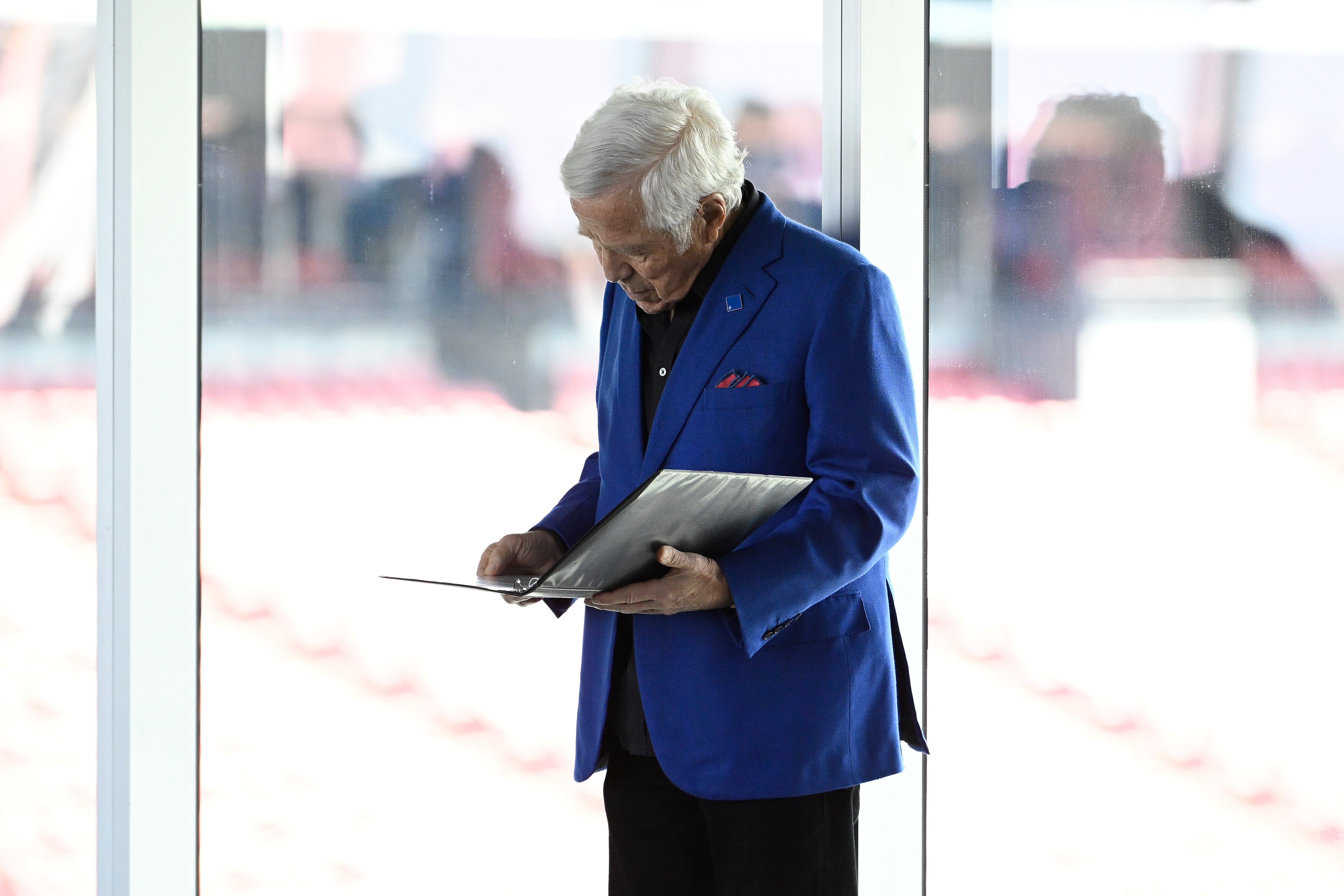Mar 13, 2025; Foxborough, MA, USA; New England Patriots owner Robert Kraft reviews his notes before a press conference at the GP Atrium at Gillette Stadium.