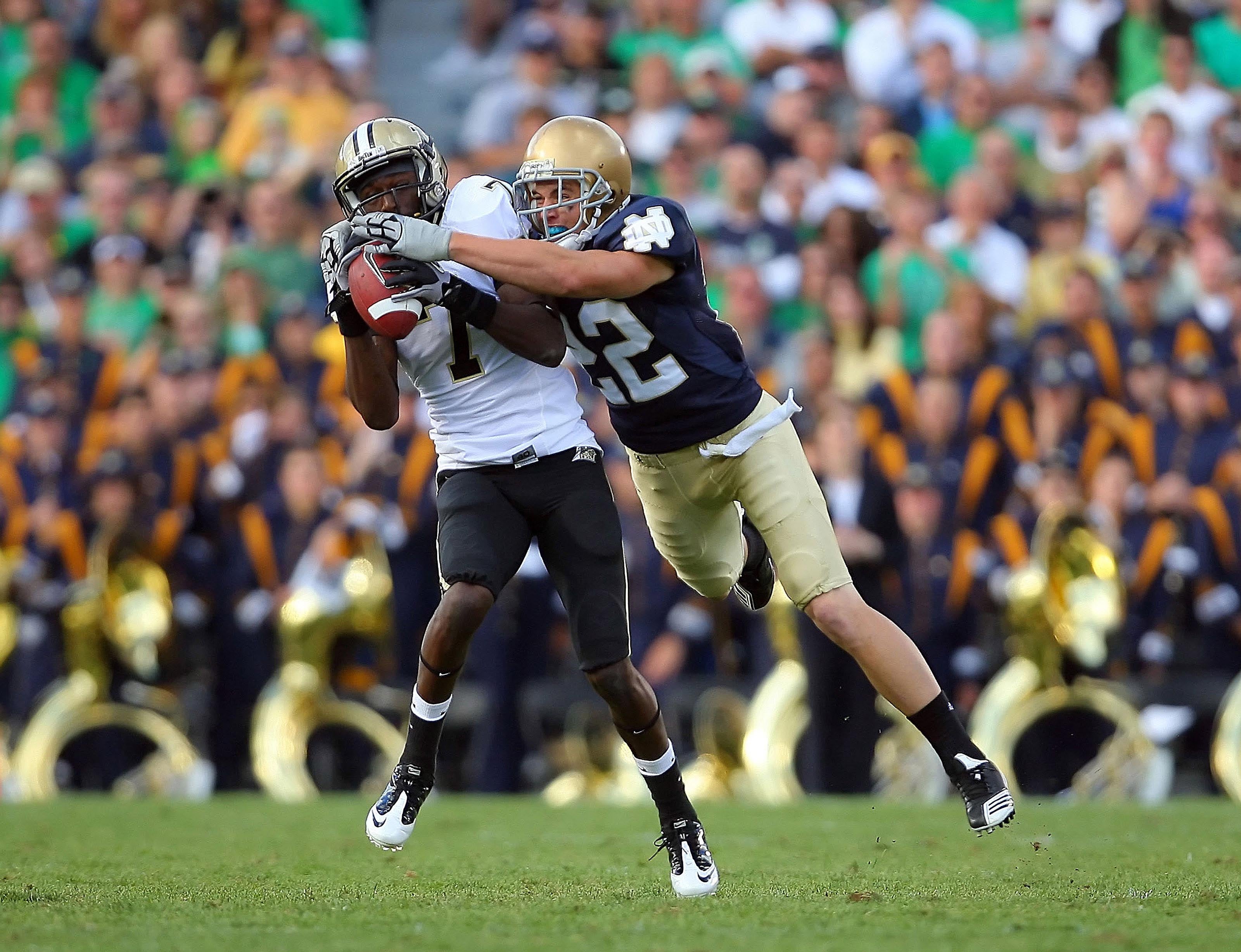 Purdue Boilermakers wide receiver Cortez Smith (7) makes a reception while being defended by Notre Dame Fighting Irish safety Harrison Smith (22) during a game at Notre Dame Stadium. Notre Dame defeated Purdue 23-12.