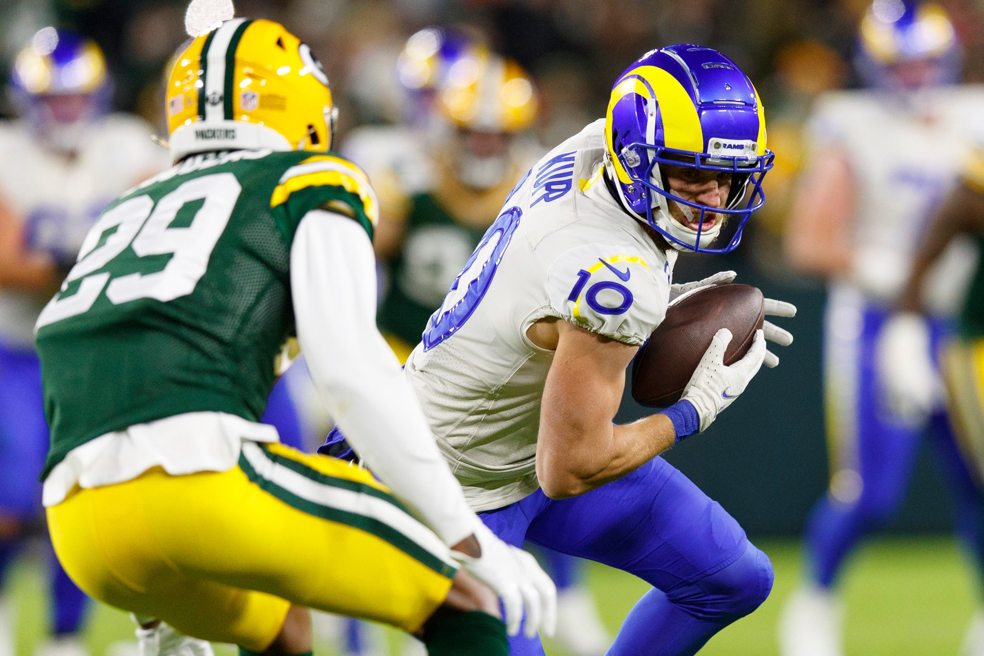 Los Angeles Rams wide receiver Cooper Kupp (10) rushes with the football after catching a pass as Green Bay Packers cornerback Rasul Douglas (29) defends during the second quarter at Lambeau Field.