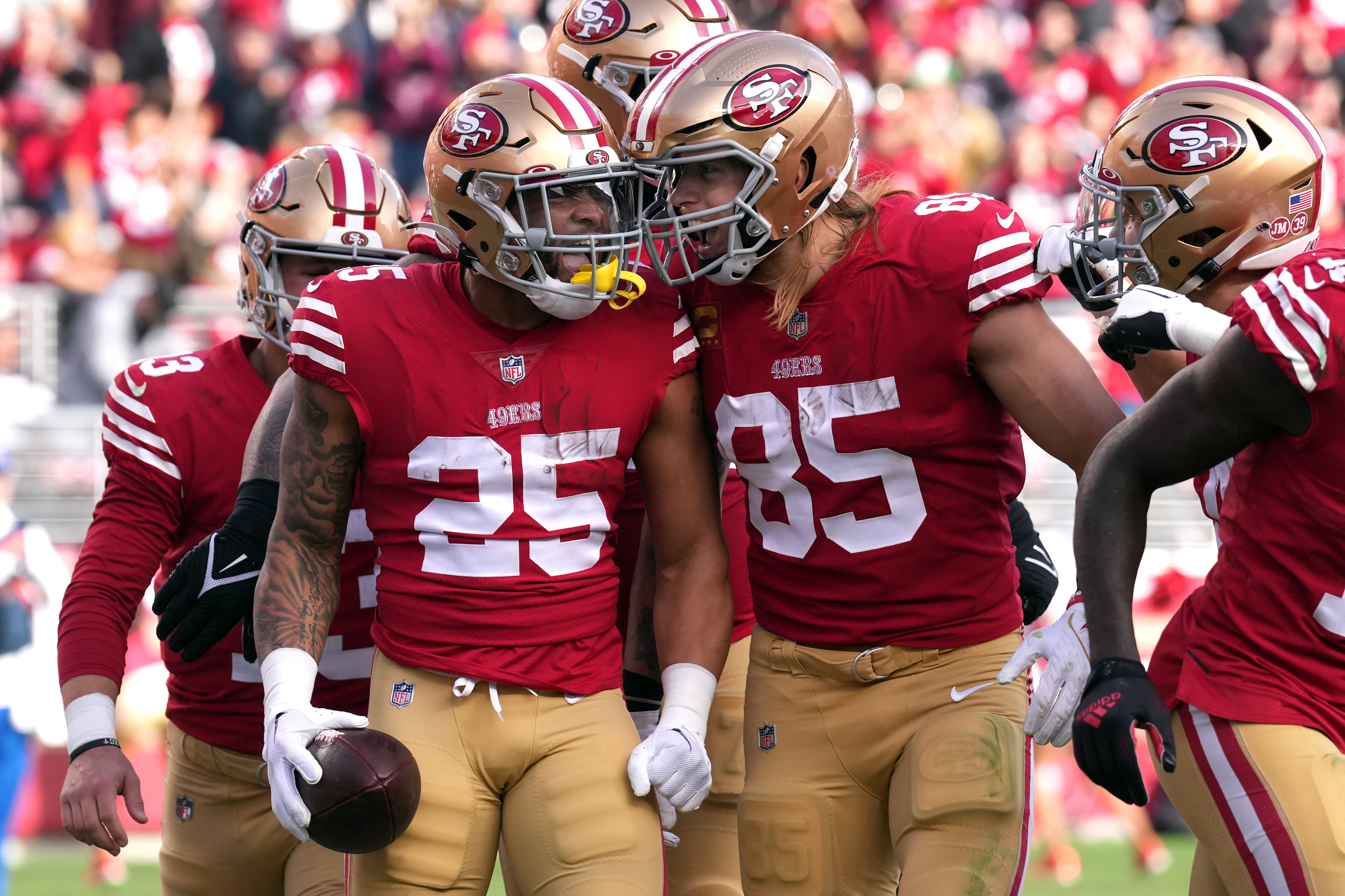 Jan 8, 2023; Santa Clara, California, USA; San Francisco 49ers running back Elijah Mitchell (25) celebrates with tight end George Kittle (85) after scoring a touchdown against the Arizona Cardinals during the second quarter at Levi's Stadium.