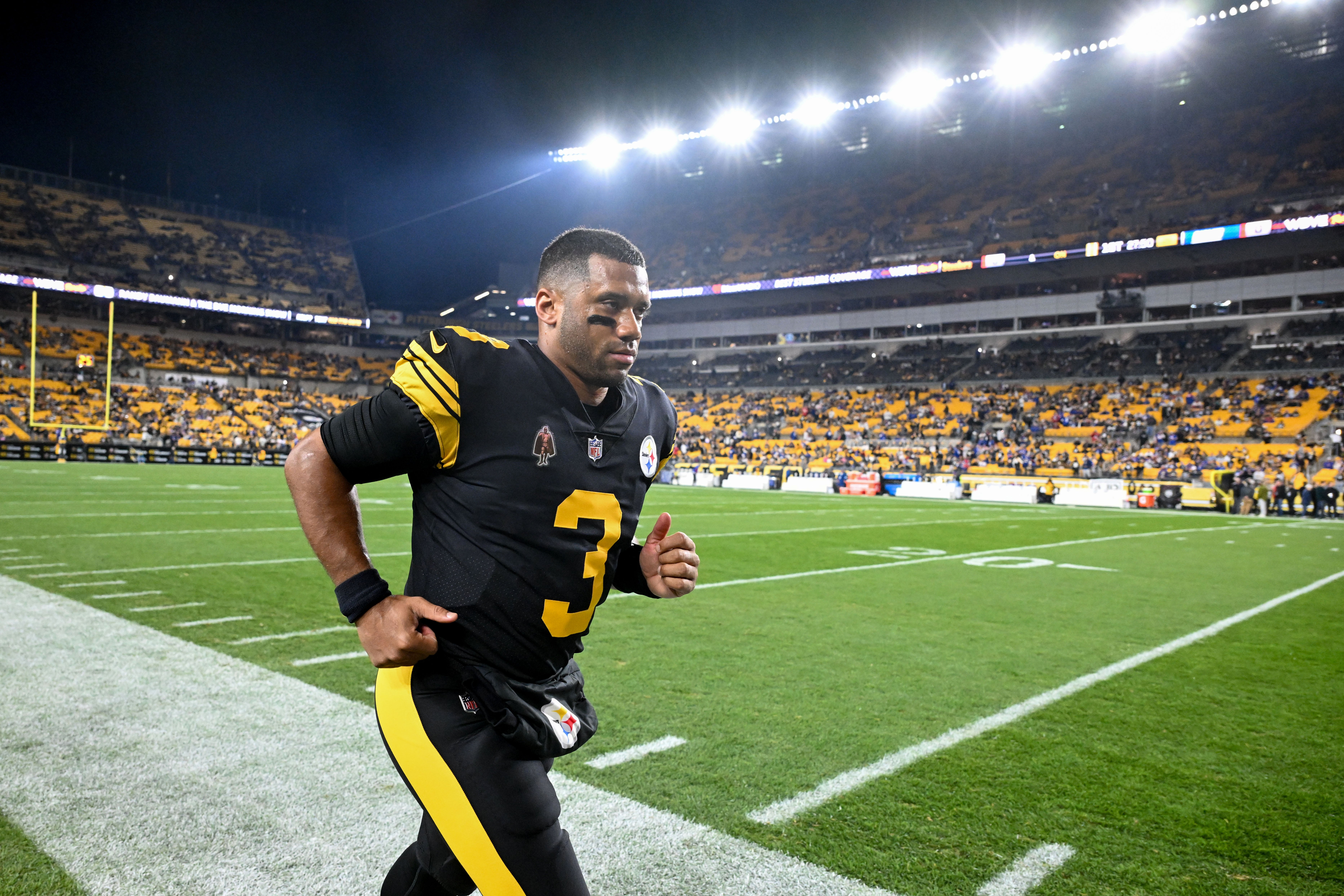 Pittsburgh Steelers quarterback Russell Wilson (3) returns to the locker room following warm ups before a game against the New York Giants at Acrisure Stadium.