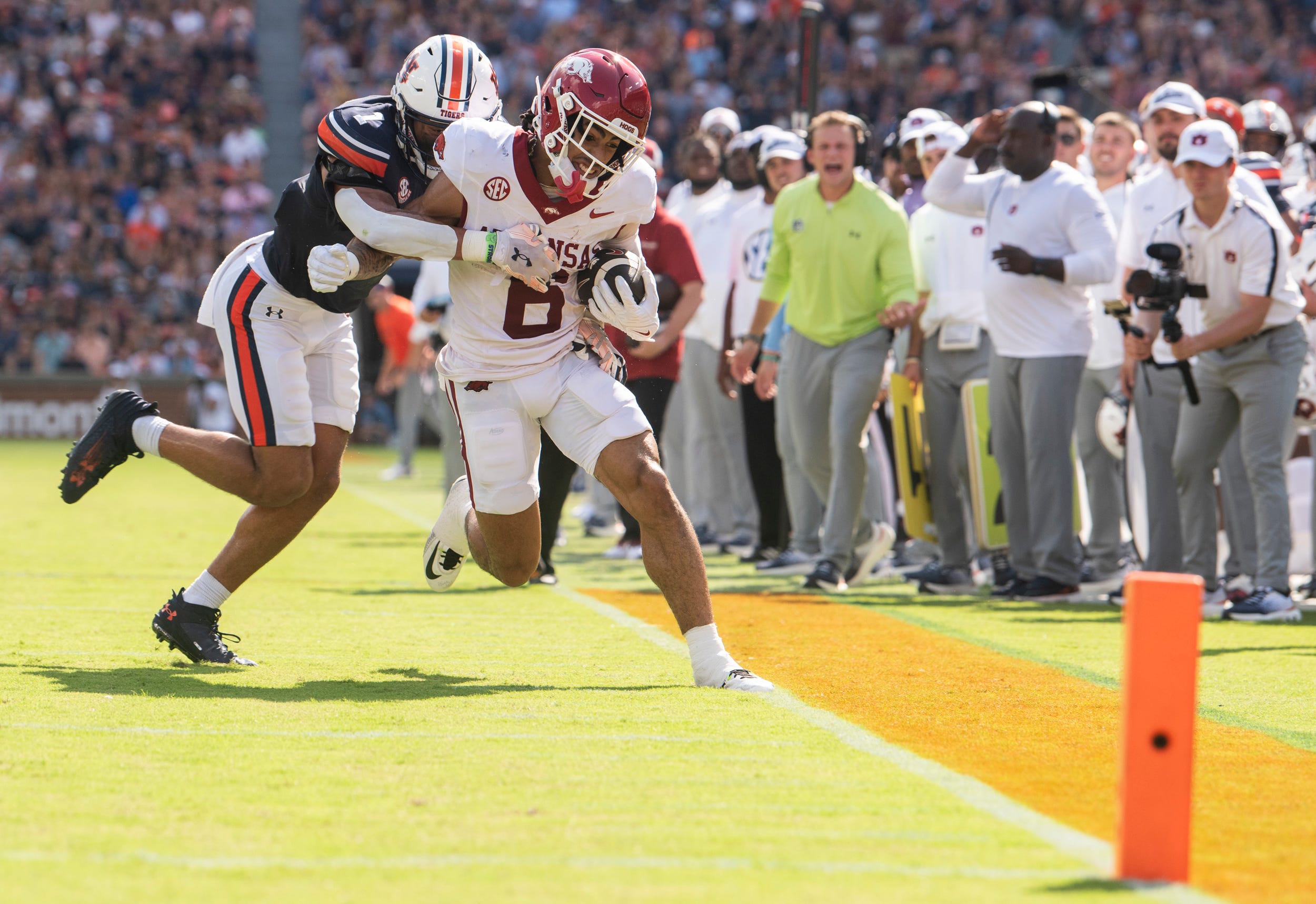 Arkansas Razorbacks wide receiver Isaiah Sategna (6) is forced out of bounds by Auburn Tigers defensive back Jerrin Thompson (1) as Auburn Tigers take on Arkansas Razorbacks at Jordan-Hare Stadium in Auburn, Ala., on Saturday, Sept. 21, 2024. Arkansas Razorbacks lead Auburn Tigers 7-0 at halftime