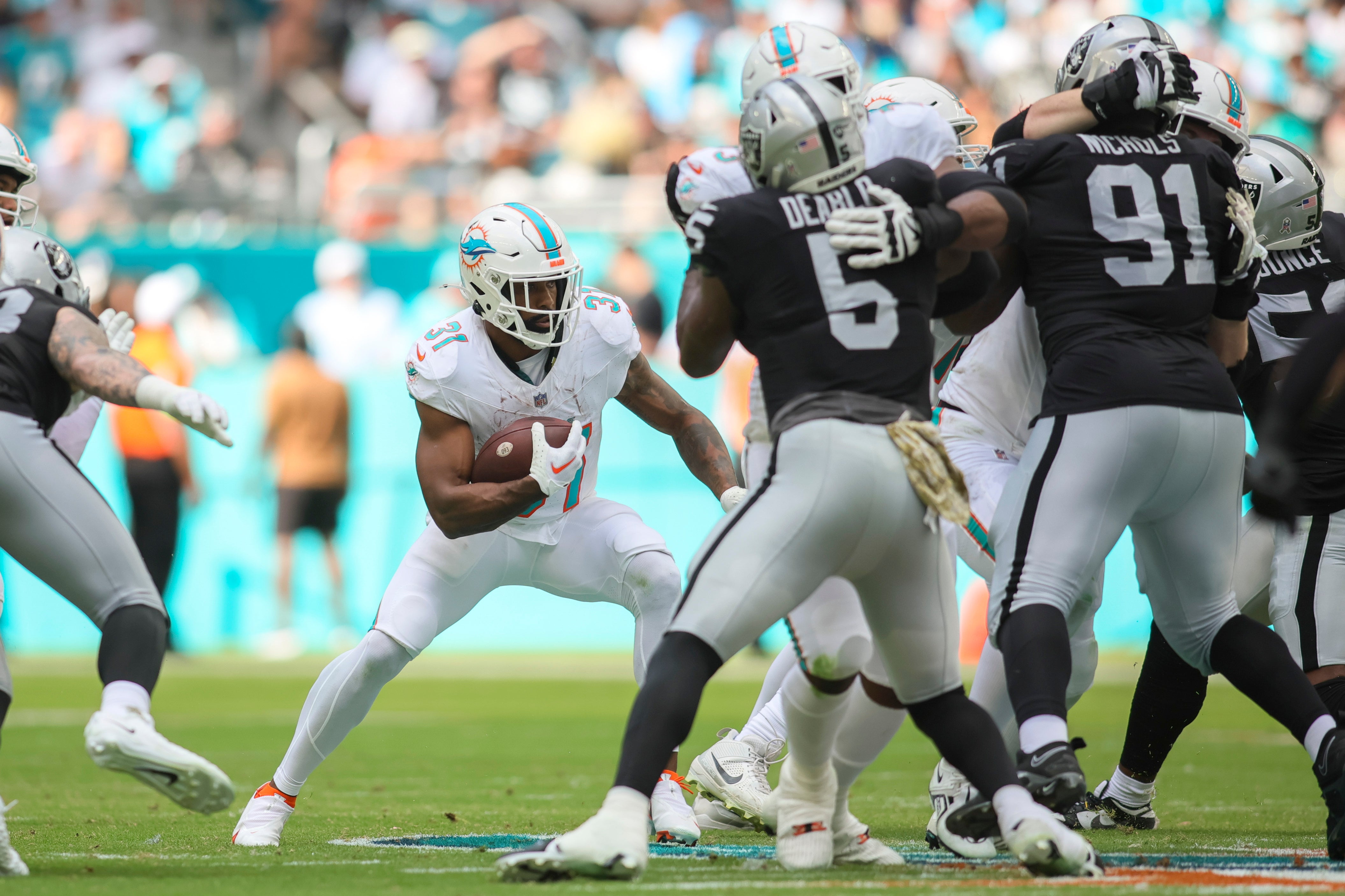 Nov 19, 2023; Miami Gardens, Florida, USA; Miami Dolphins running back Raheem Mostert (31) runs with the football against the Las Vegas Raiders during the second quarter at Hard Rock Stadium.