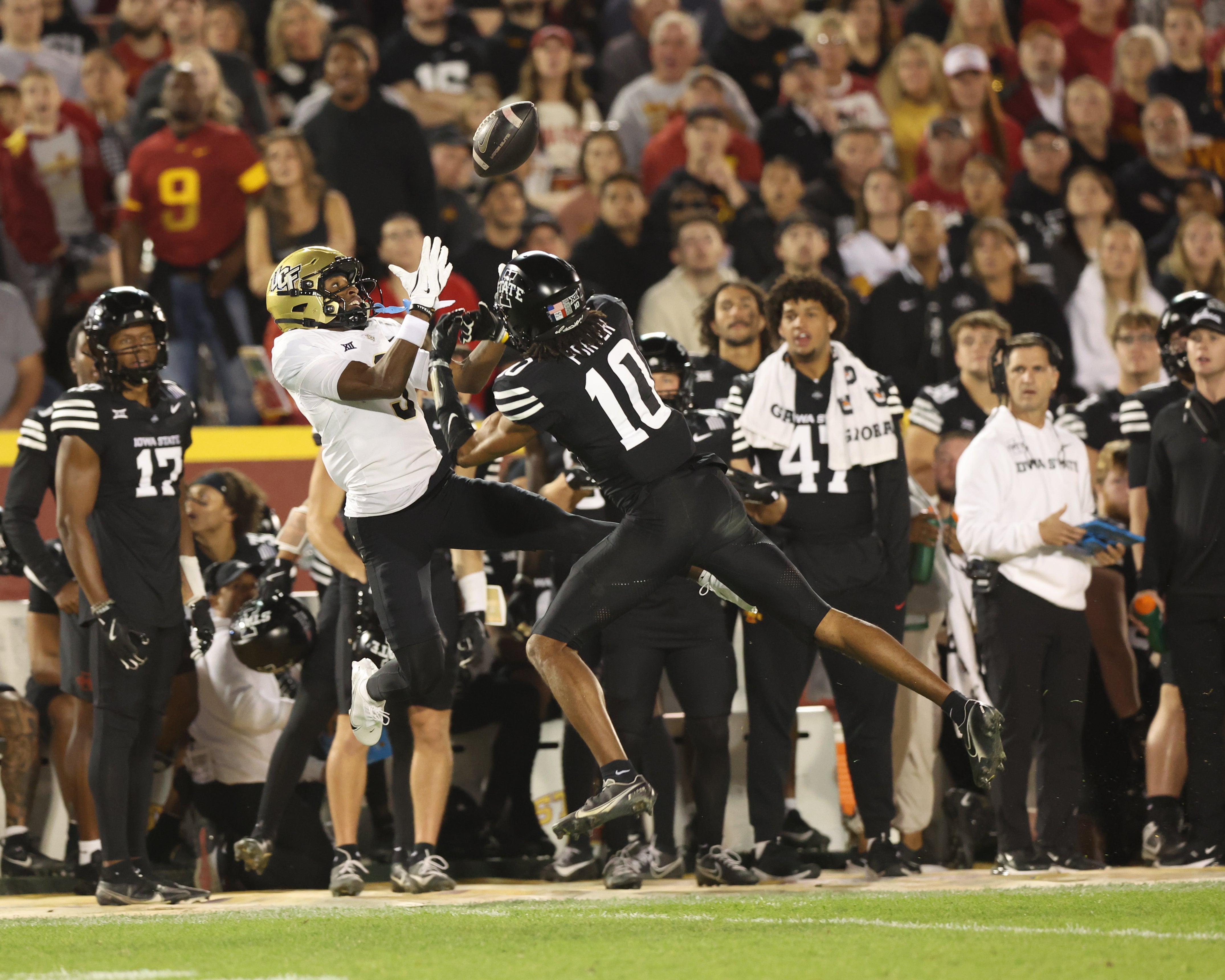 Oct 19, 2024; Ames, Iowa, USA; UCF Knights wide receiver Ja'Varrius Johnson (9) and Iowa State Cyclones defensive back Darien Porter (10) battle for a pass at Jack Trice Stadium.