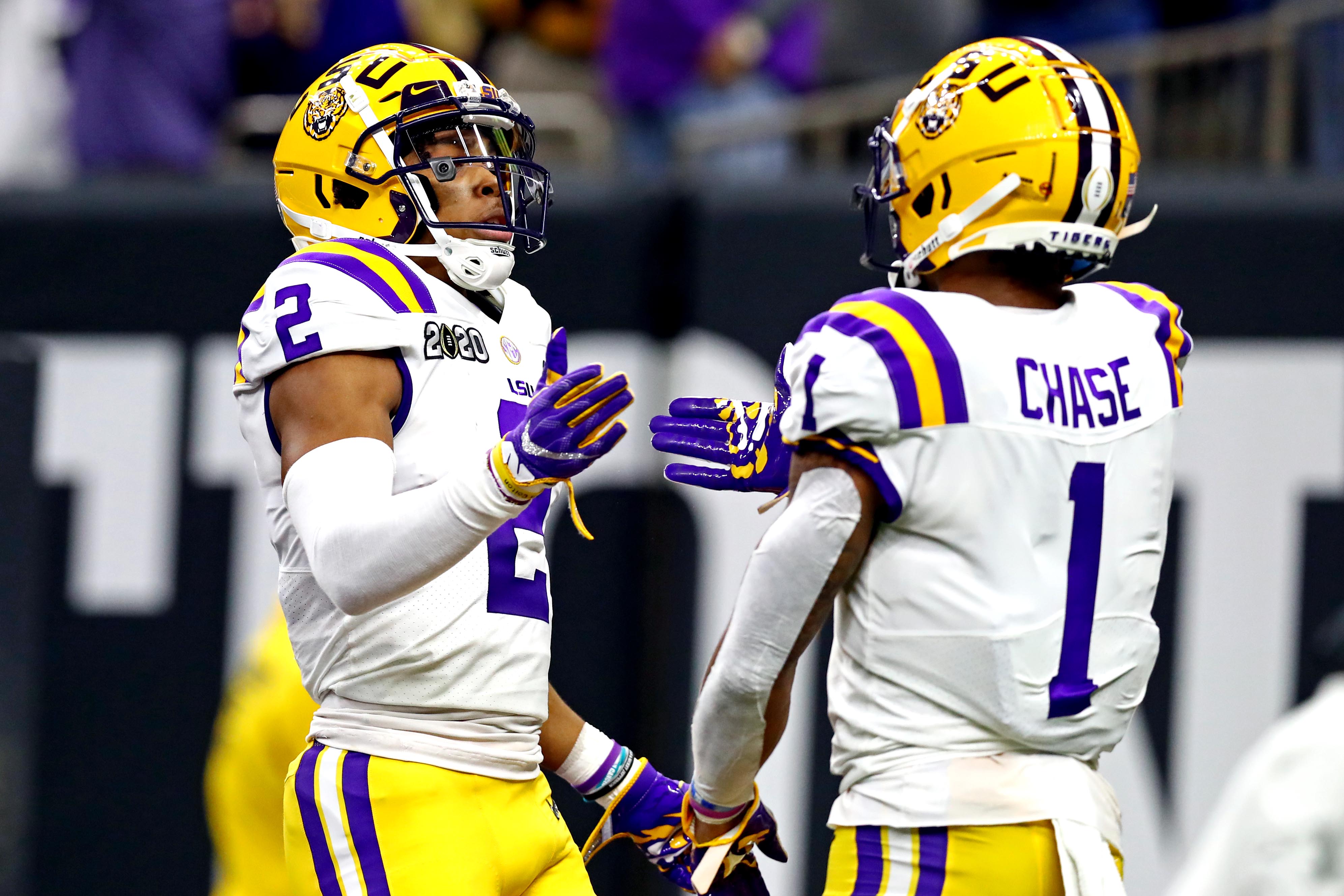 Jan 13, 2020; New Orleans, Louisiana, USA; LSU Tigers wide receiver Justin Jefferson (2) and LSU Tigers wide receiver Ja'Marr Chase (1) celebrate after a play during the second quarter against the Clemson Tigers in the College Football Playoff national championship game at Mercedes-Benz Superdome.