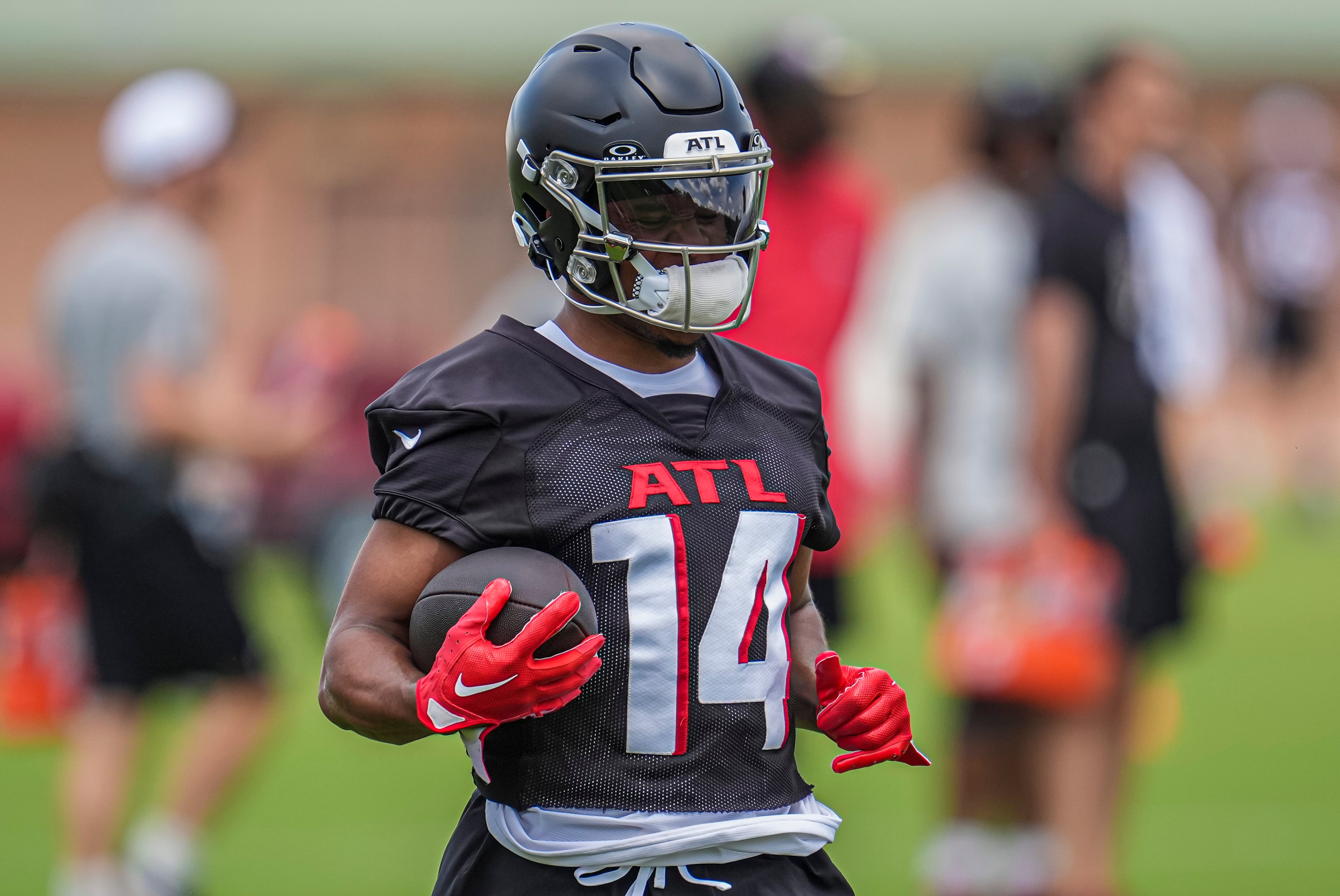 Jun 3, 2024; Atlanta, GA, USA; Atlanta Falcons wide receiver Rondale Moore (14) runs with the ball during Falcons OTA at the Falcons Training facility.