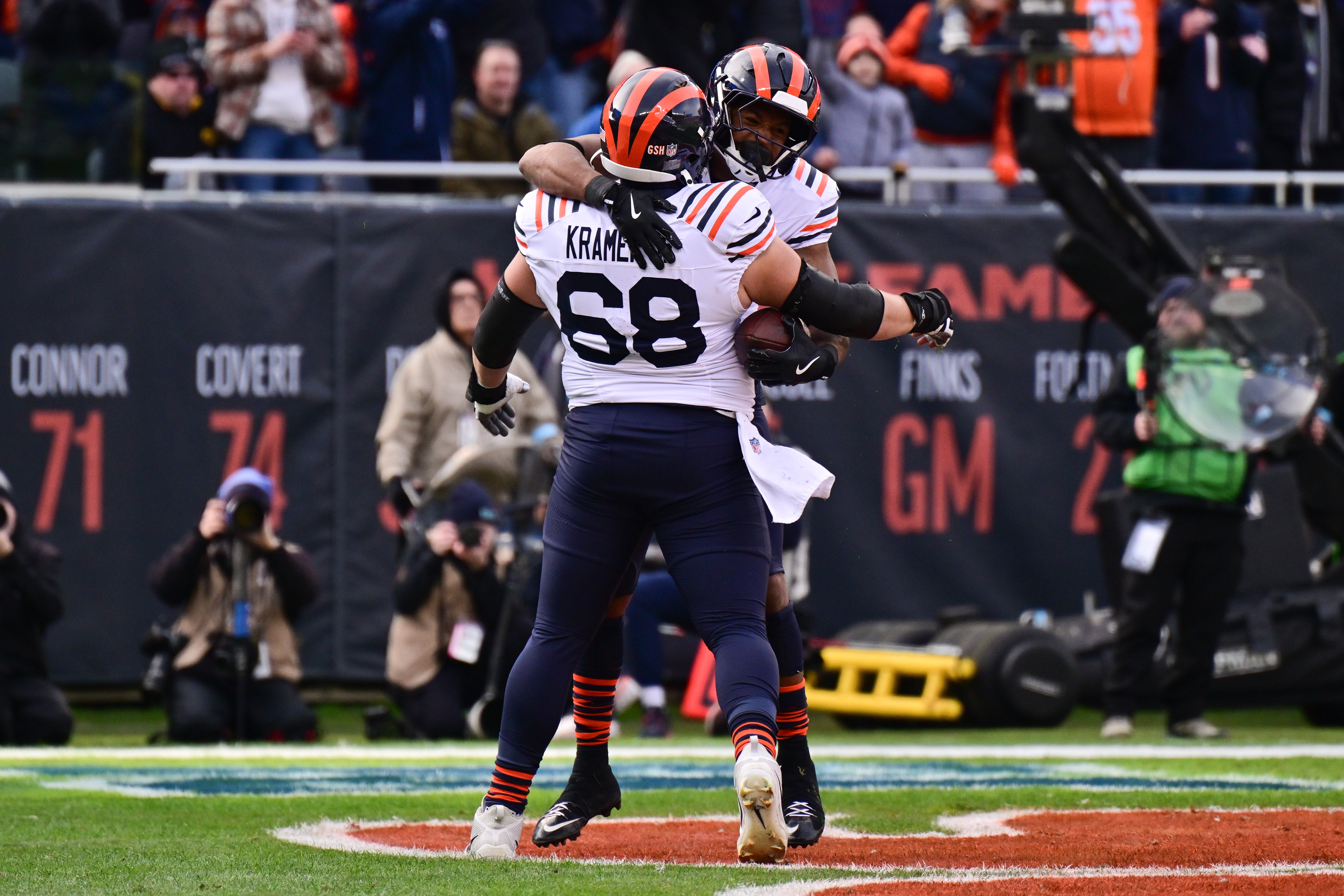 Nov 24, 2024; Chicago, Illinois, USA; Chicago Bears running back Roschon Johnson (23) celebrates his rushing touchdown with center Doug Kramer (68) against the Minnesota Vikings during the first quarter at Soldier Field.