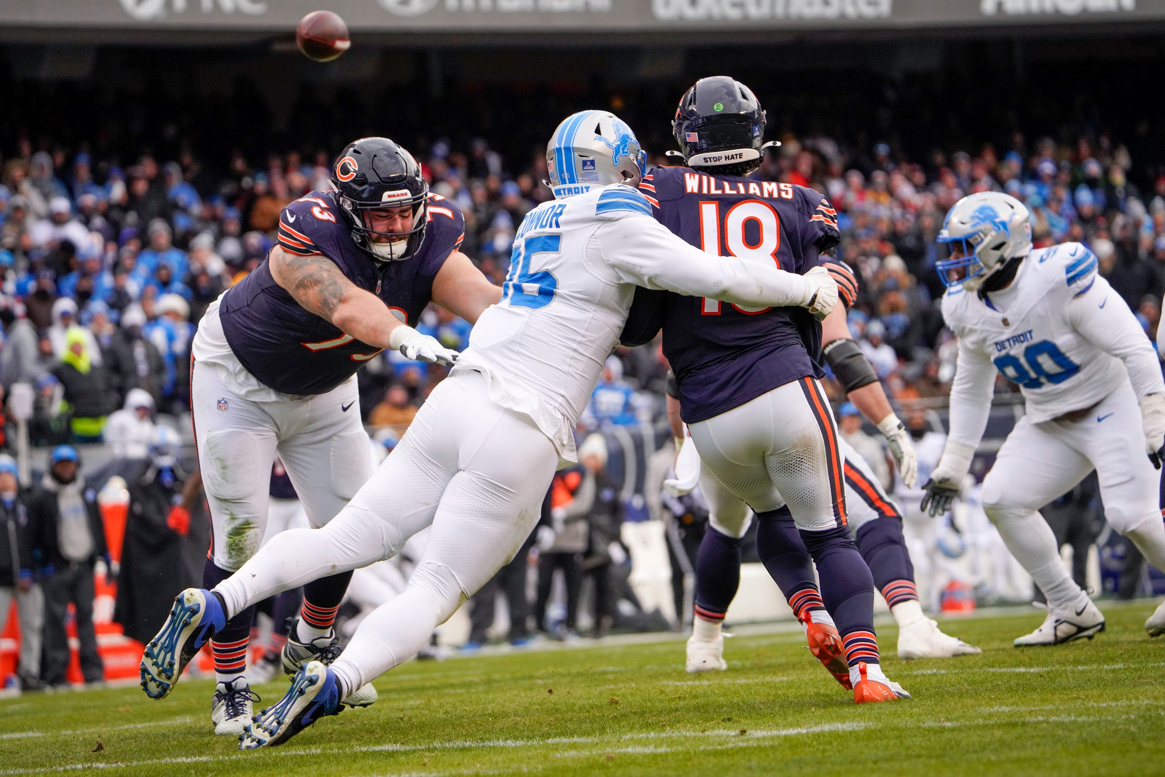Chicago Bears quarterback Caleb Williams (18) attempts a last second pass as Detroit Lions defensive end Pat O'Connor (95) almost sacks him at Soldier Field during a game at Soldier Field in Chicago, Ill., on Sunday, Dec. 22, 2024.