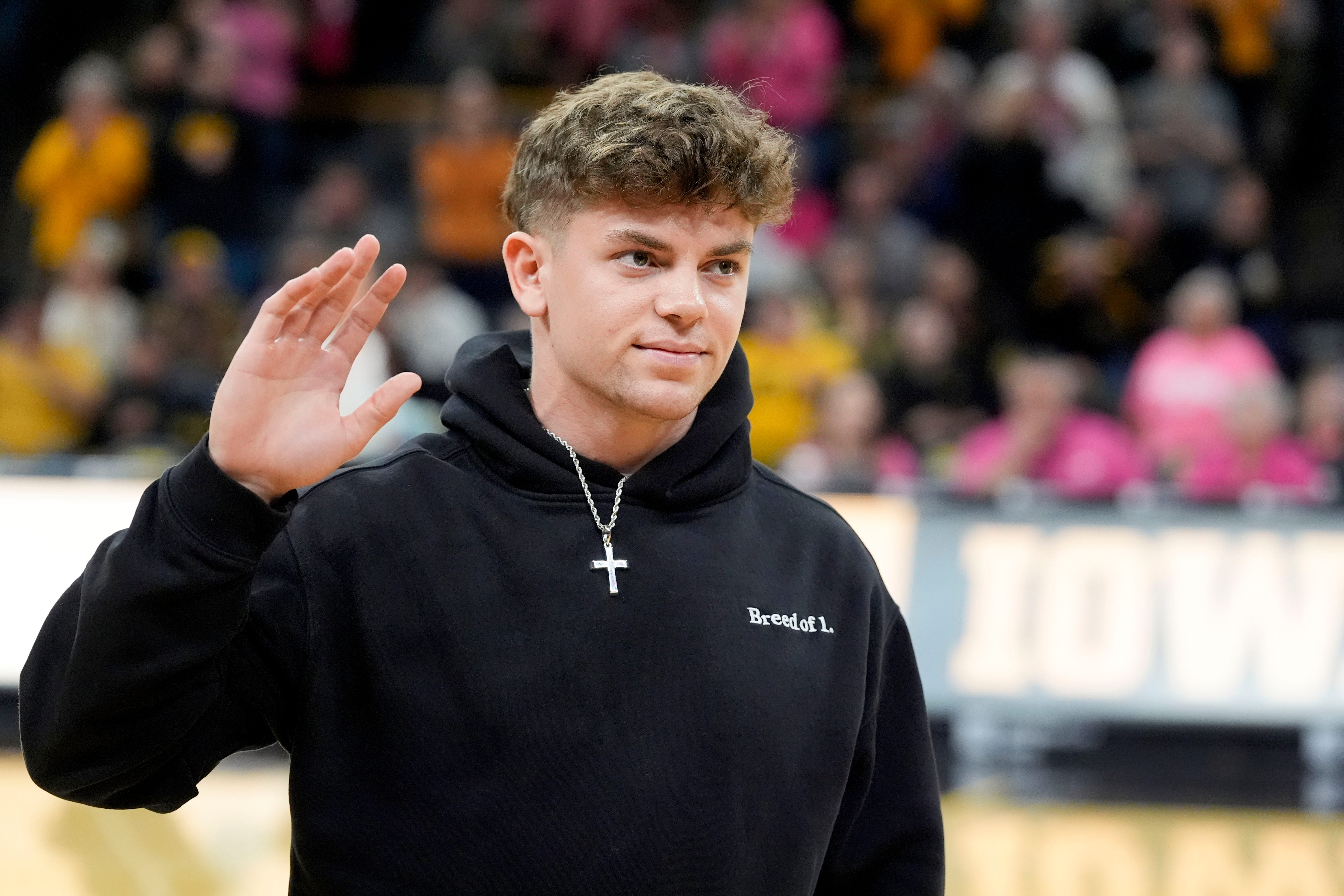 Former Iowa football player and Super Bowl LIX champion Cooper DeJean is interviewed on court during halftime of the Iowa womens basketball game against UCLA Sunday, Feb. 23, 2025 at Carver-Hawkeye.