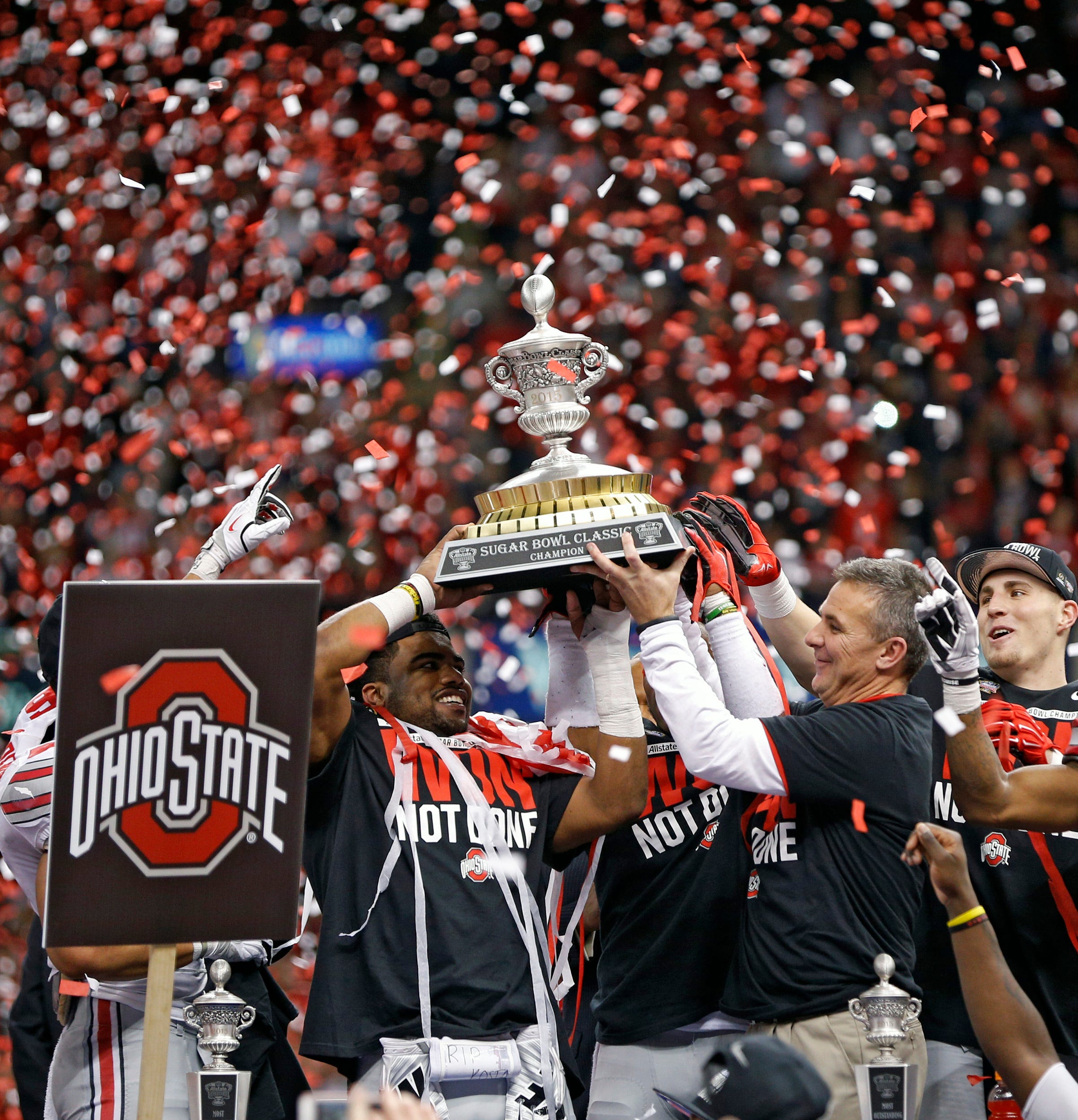 Ohio State Buckeyes running back Ezekiel Elliott (15) and Ohio State Buckeyes head coach Urban Meyer hold up the Sugar Bowl trophy after beating Alabama Crimson Tide in the Allstate Sugar Bowl college football Playoff Semifinal game at the Mercedes-Benz Superdome in New Orleans, Louisiana on January 1, 2015. (Dispatch photo by Kyle Robertson)