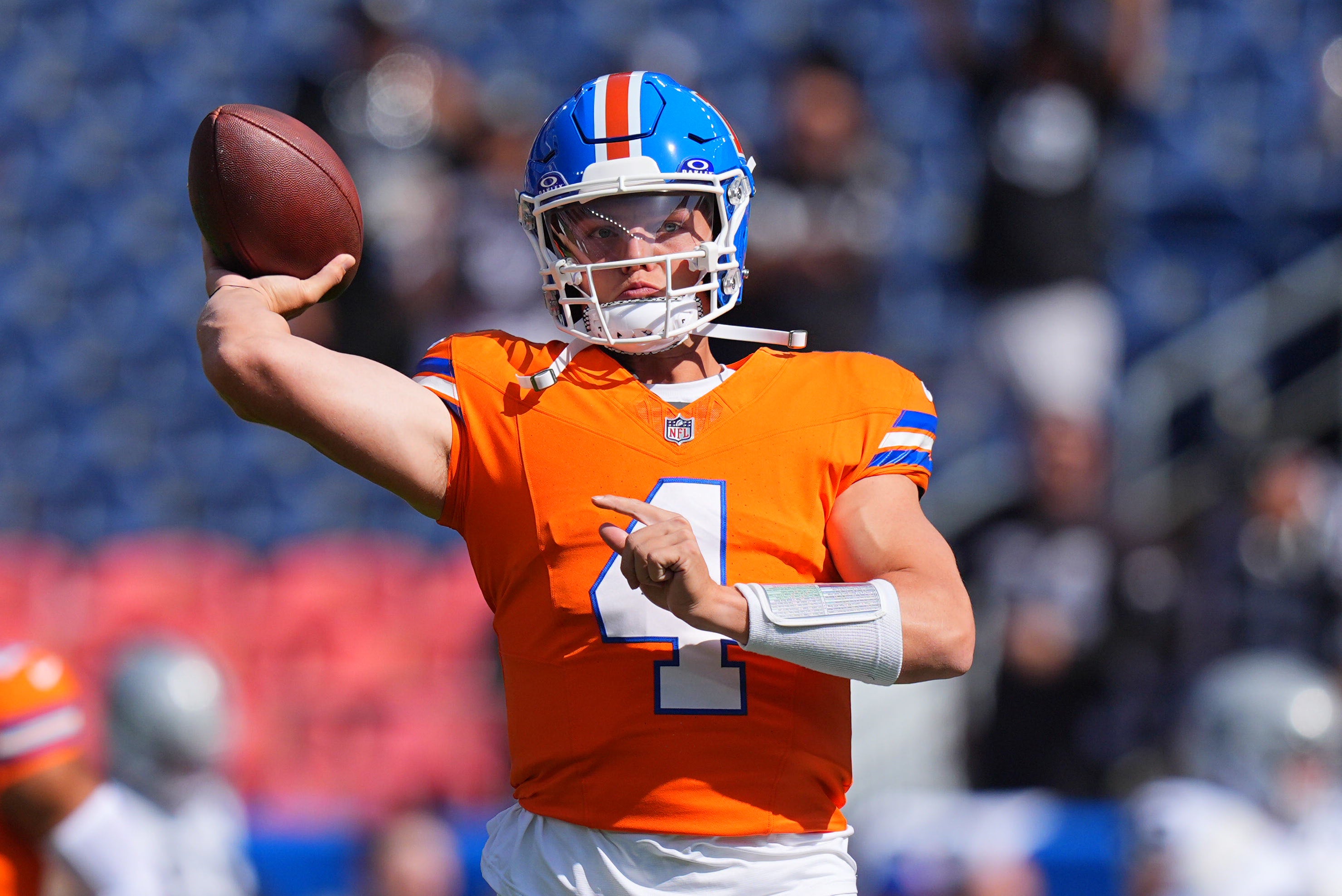 Denver Broncos quarterback Zach Wilson (4) warms up before the game against the Las Vegas Raiders at Empower Field at Mile High.