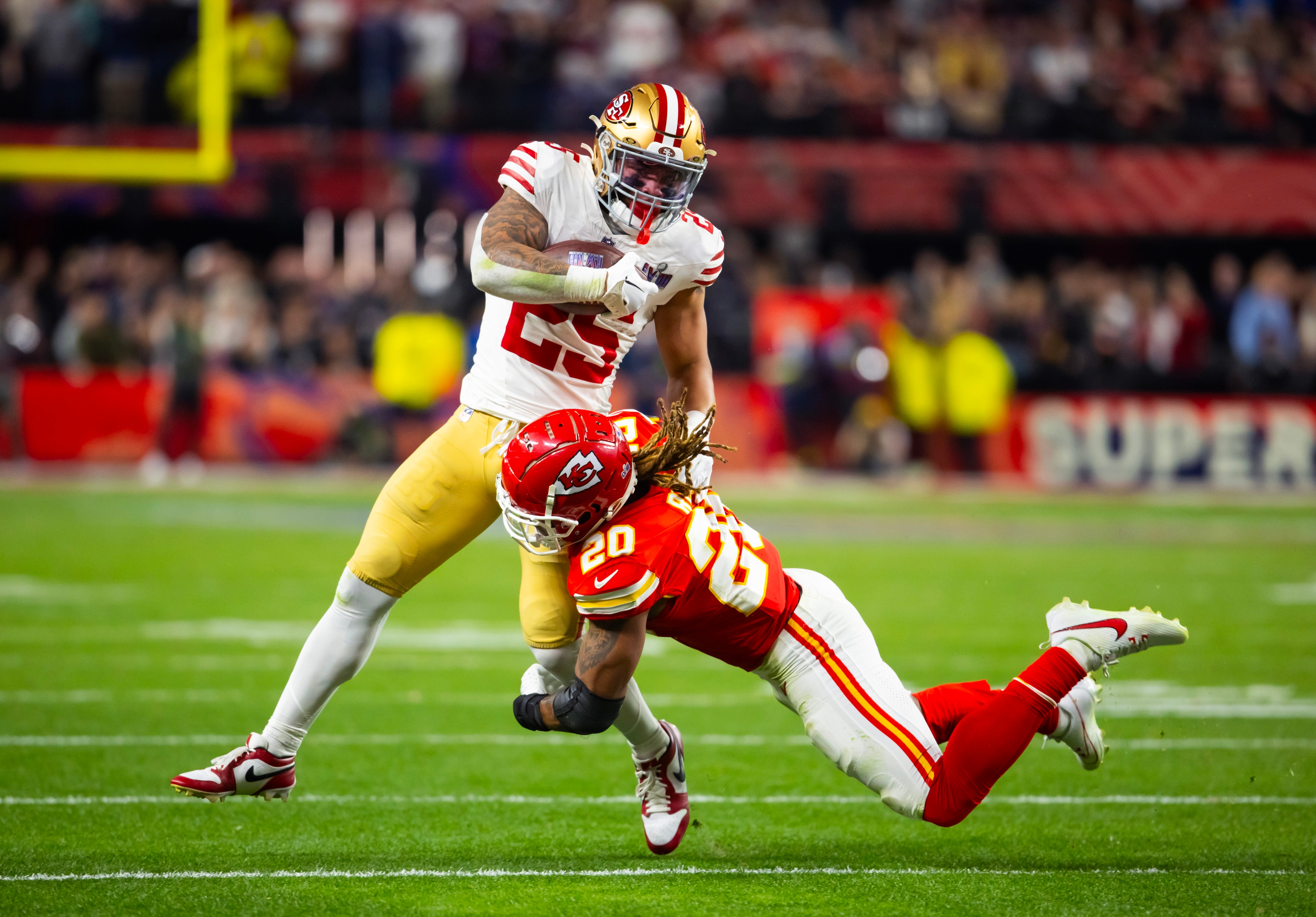 Feb 11, 2024; Paradise, Nevada, USA; San Francisco 49ers running back Elijah Mitchell (25) is tackled by Kansas City Chiefs safety Justin Reid (20) in Super Bowl LVIII at Allegiant Stadium.