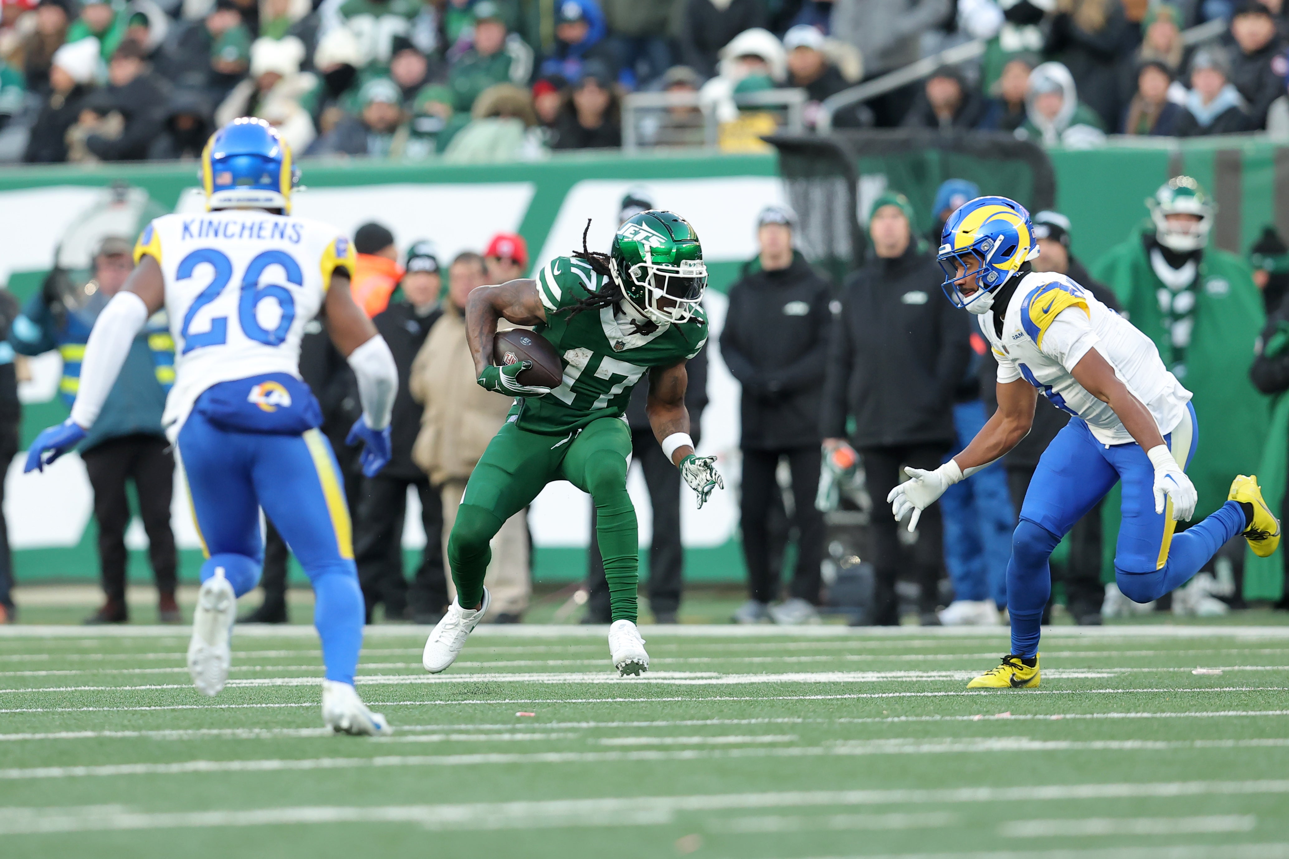 Dec 22, 2024; East Rutherford, New Jersey, USA; New York Jets wide receiver Davante Adams (17) runs with the ball against Los Angeles Rams safety Kamren Kinchens (26) and cornerback Ahkello Witherspoon (4) during the fourth quarter at MetLife Stadium.