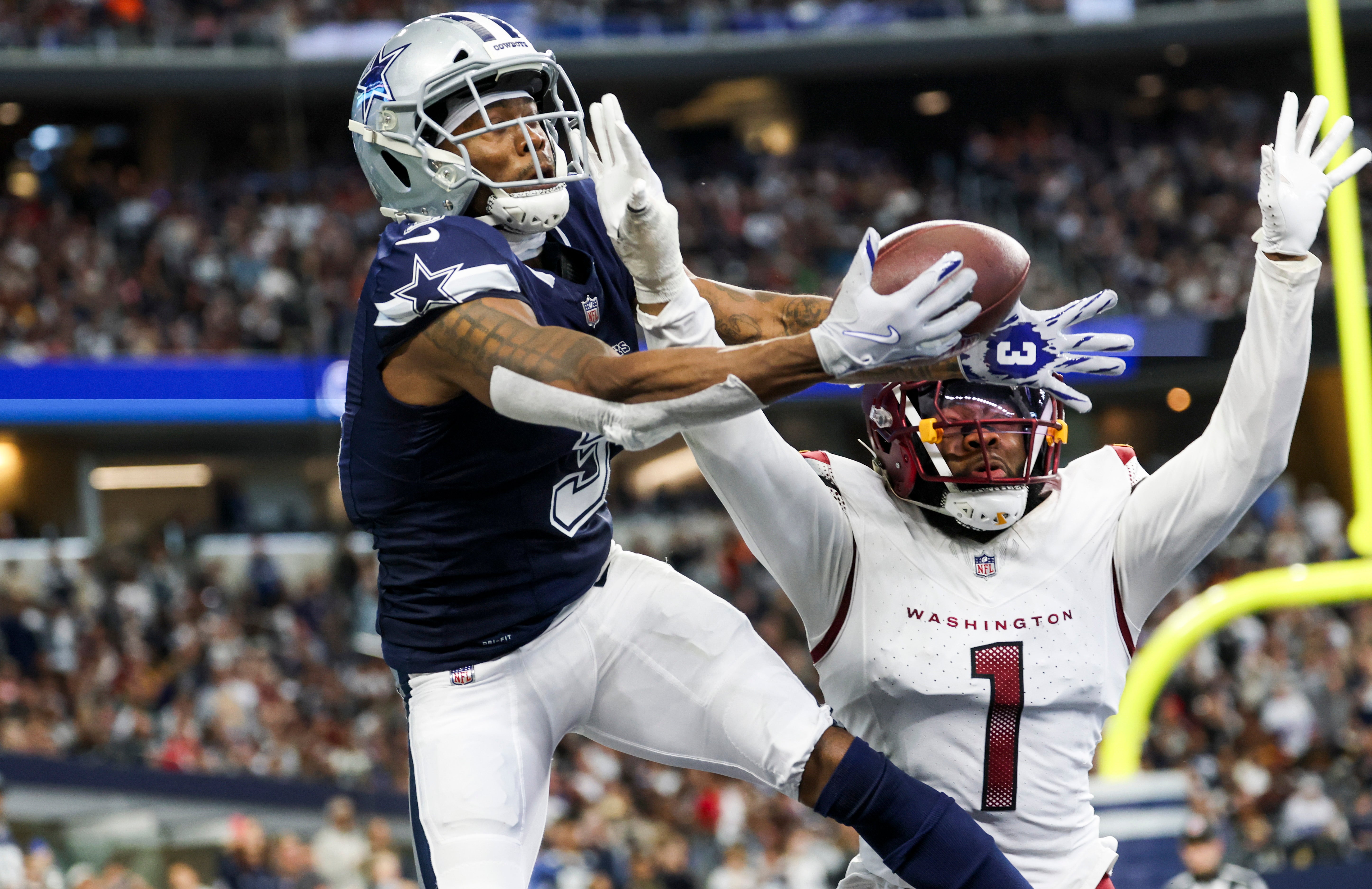 Dallas Cowboys wide receiver Brandin Cooks (3) cannot make a touchdown catch as Washington Commanders cornerback Noah Igbinoghene (1) defends during the second half at AT&T Stadium.