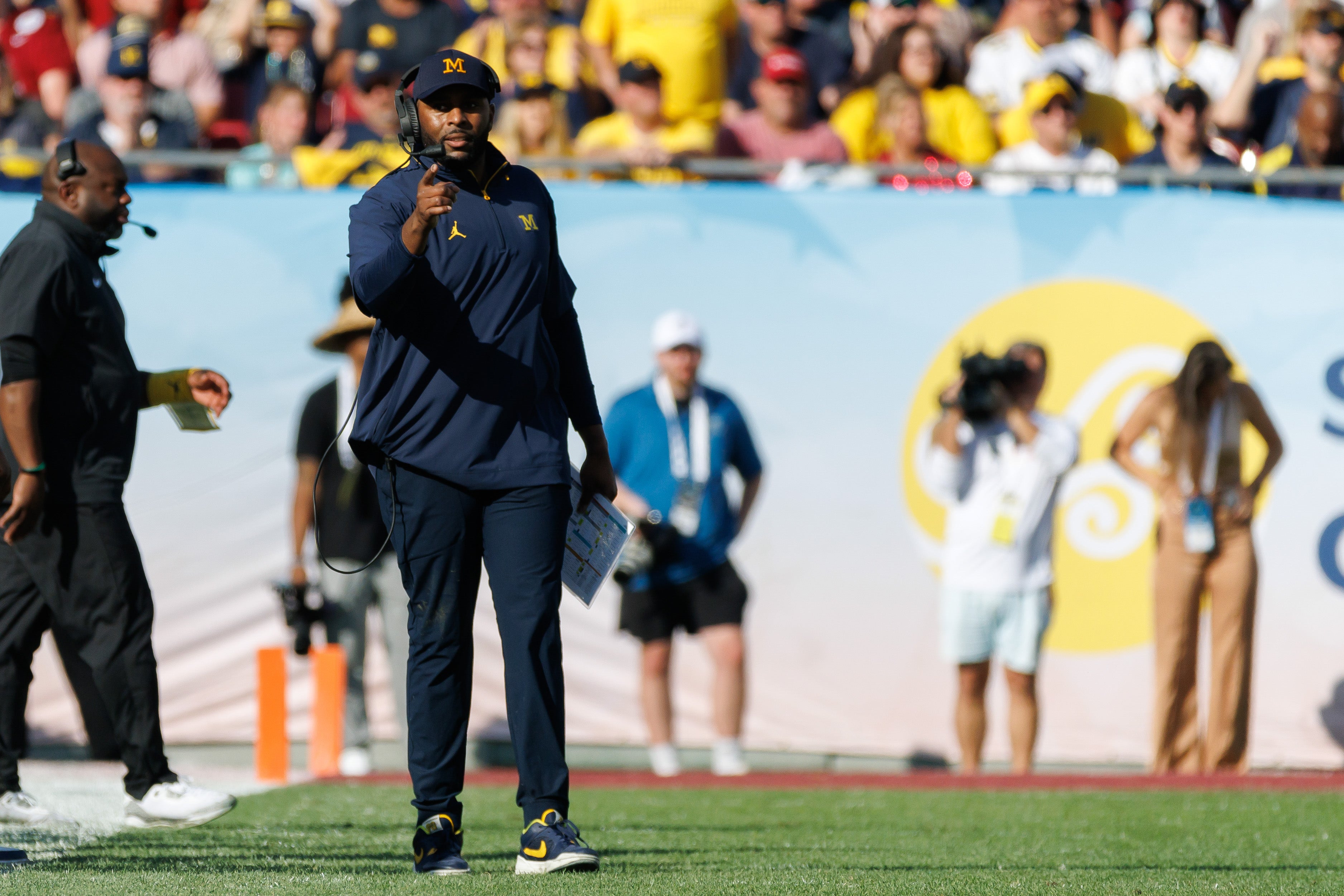 Dec 31, 2024; Tampa, FL, USA; Michigan Wolverines head coach Sherrone Moore gestures from the field against the Alabama Crimson Tide during the second half at Raymond James Stadium.