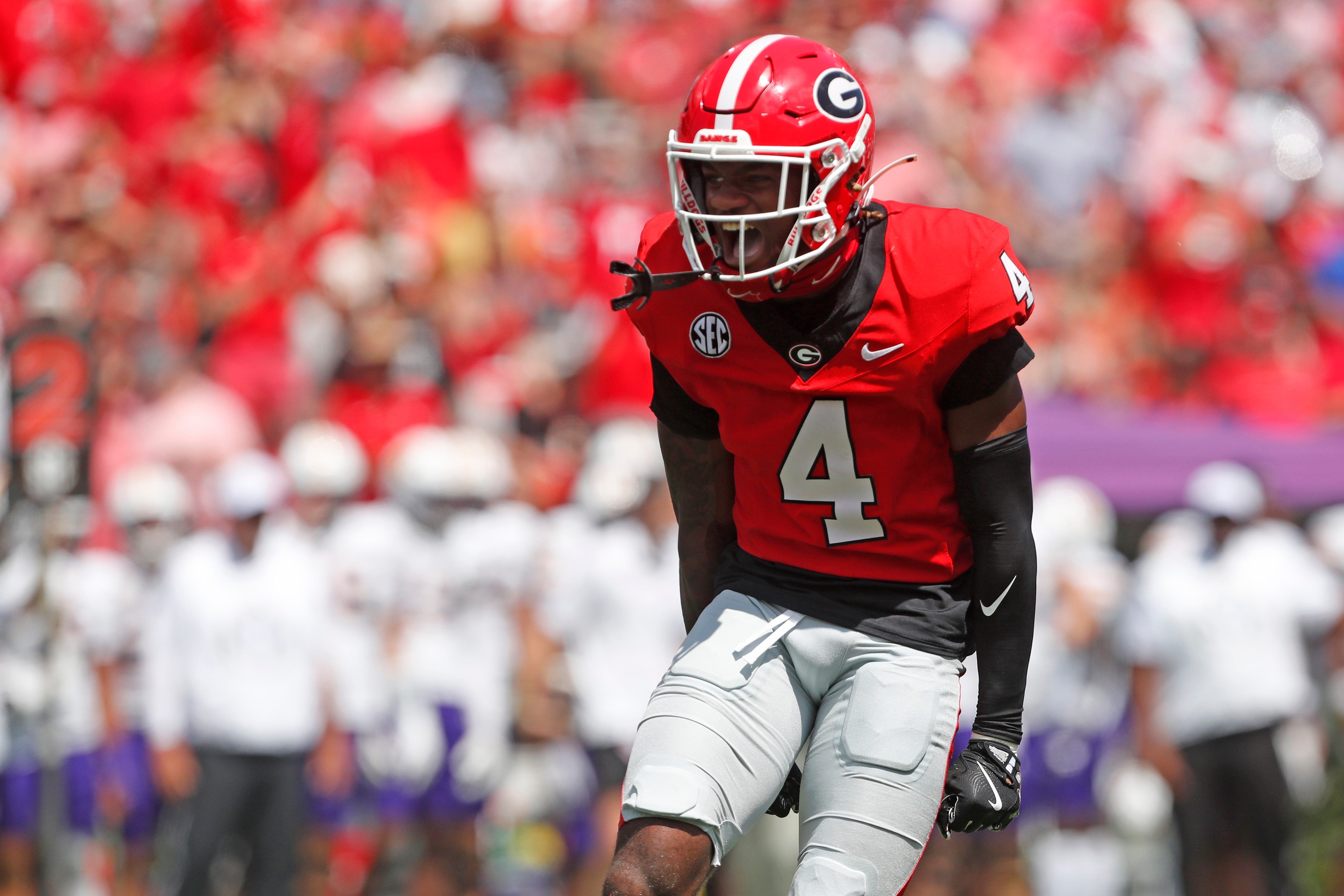 Georgia defensive back KJ Bolden (4) celebrates after sacking Tennessee Tech quarterback Jordyn Potts (5) during the first half of a NCAA college football game against Tennessee Tech in Athens.