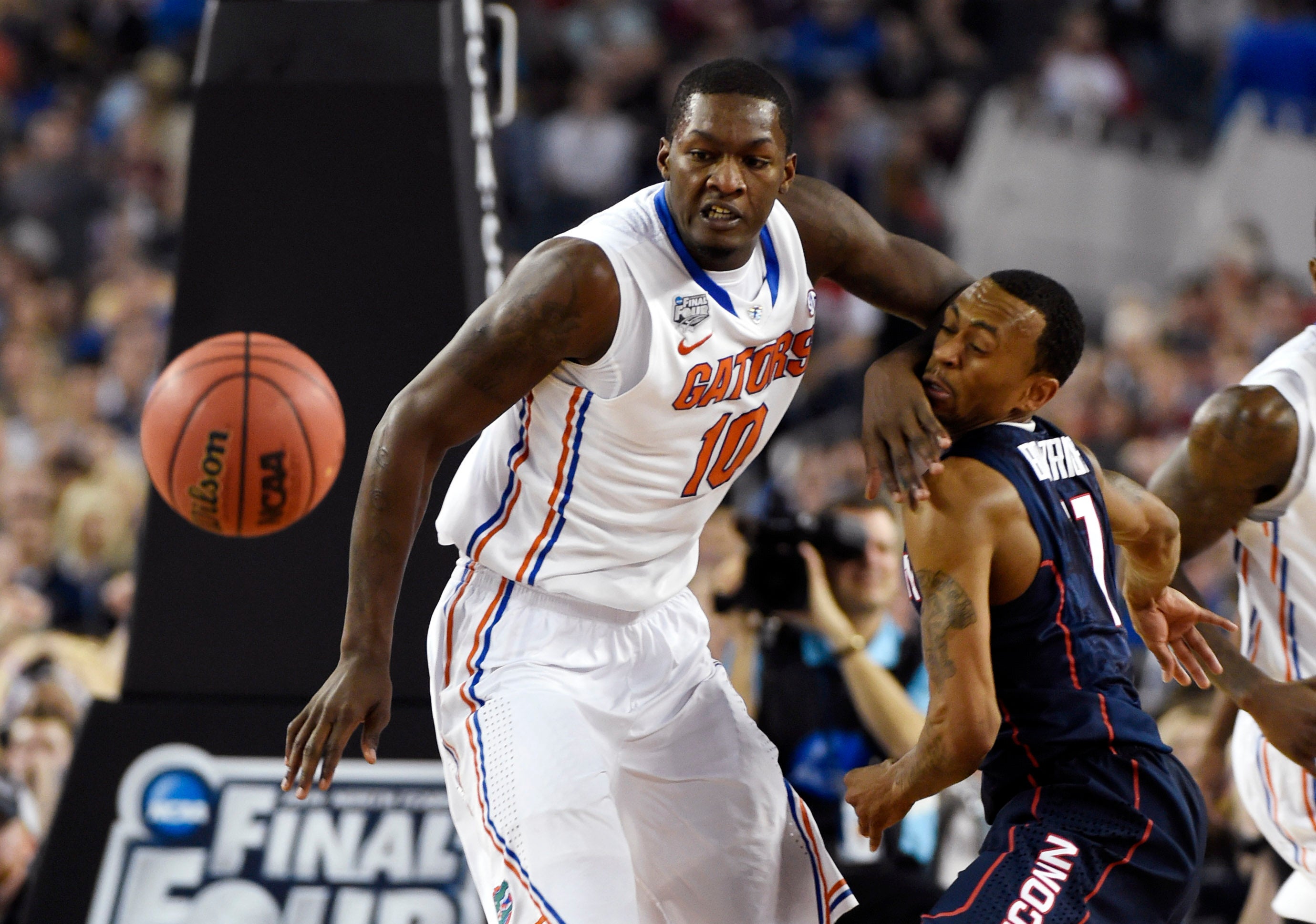 Apr 5, 2014; Arlington, TX, USA; Connecticut Huskies guard Ryan Boatright (right) gets hit in the face by Florida Gators forward Dorian Finney-Smith (10) while chasing the ball in the second half during the semifinals of the Final Four in the 2014 NCAA Mens Division I Championship tournament at AT&T Stadium.