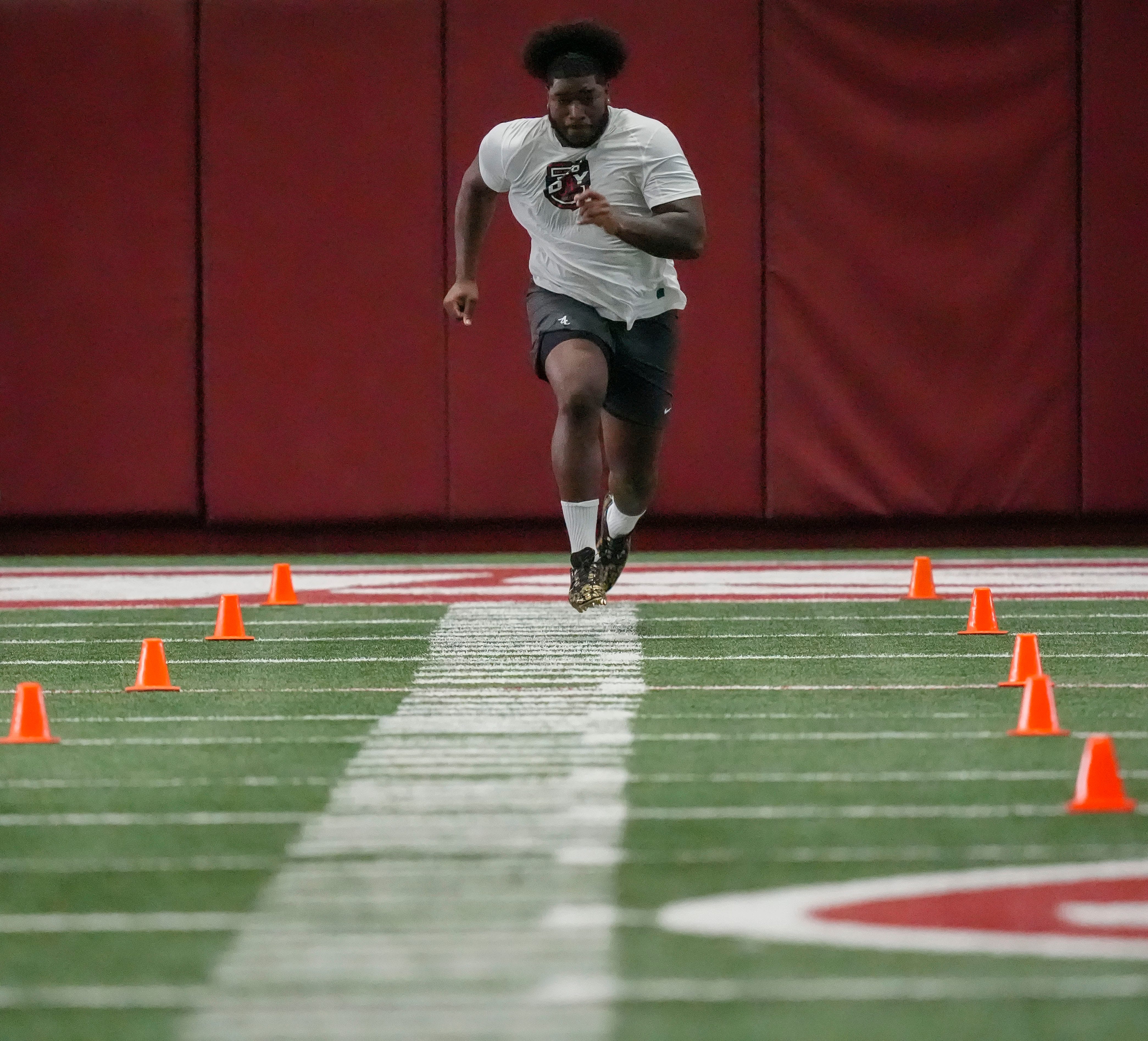 Offensive lineman Tyler Booker runs the 40 yard dash at the University of Alabama Pro Day as several Crimson Tide players worked out for NFL teams in the Hank Crisp Indoor Practice Facility.