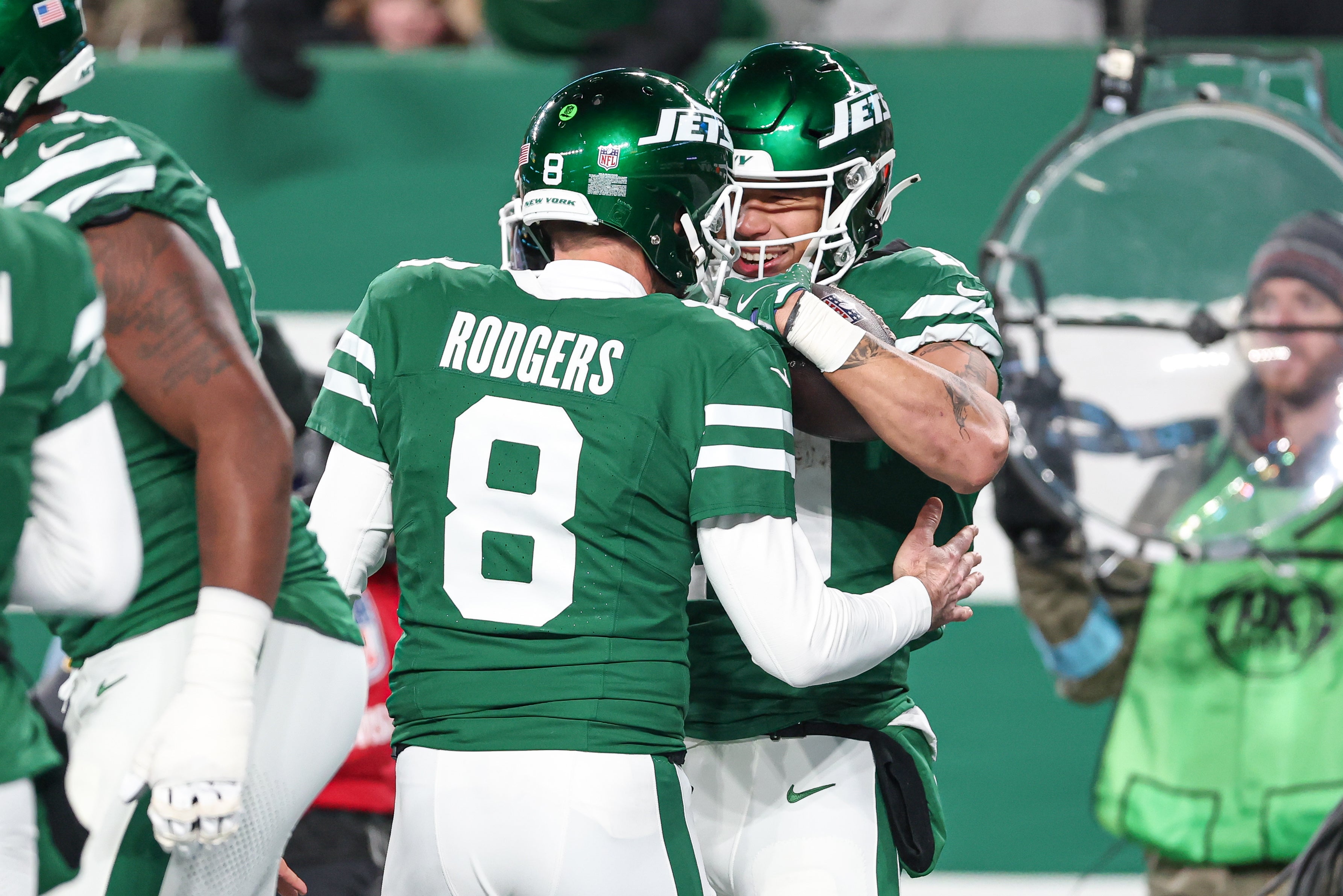 New York Jets wide receiver Allen Lazard (10) celebrates his touchdown reception with quarterback Aaron Rodgers (8) during the first half against the Miami Dolphins at MetLife Stadium.