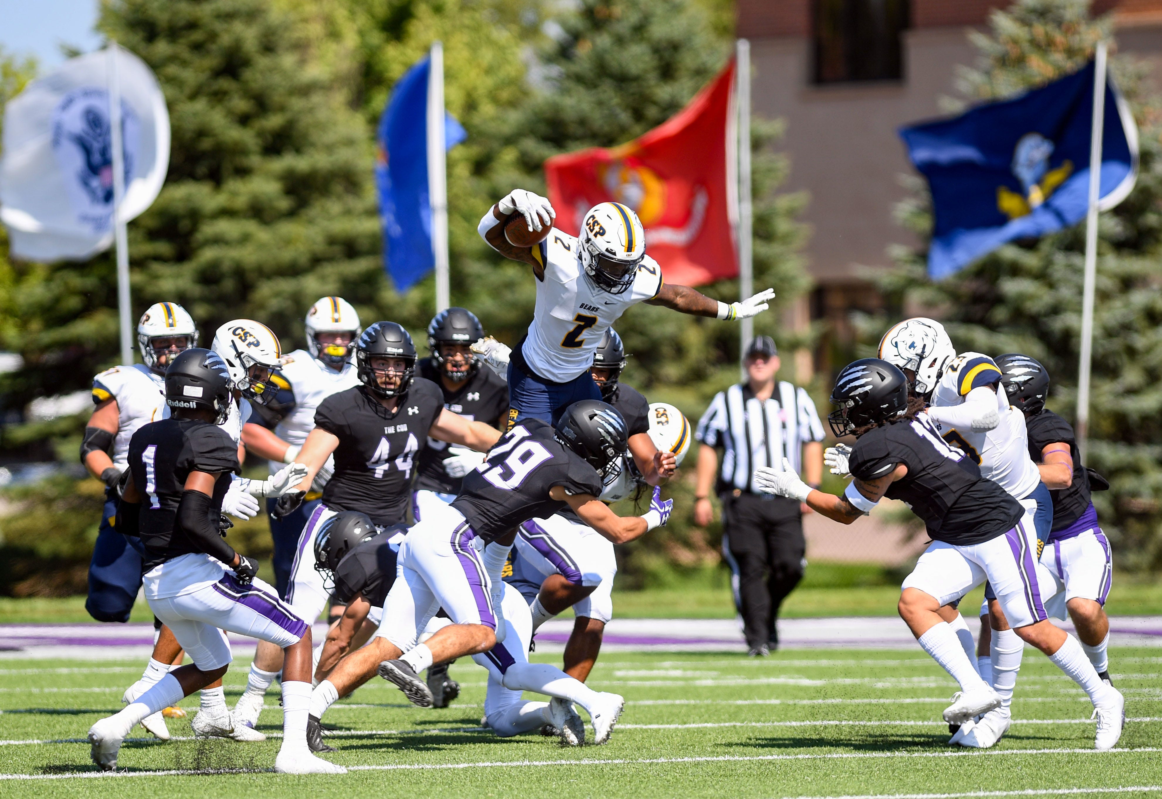Concordia University, St. Paul's Jaylin Richardson leaps over a mix of University of Sioux Falls players on Saturday, September 18, 2021, at Bob Young Field in Sioux Falls. Usf Vs Csp 007  