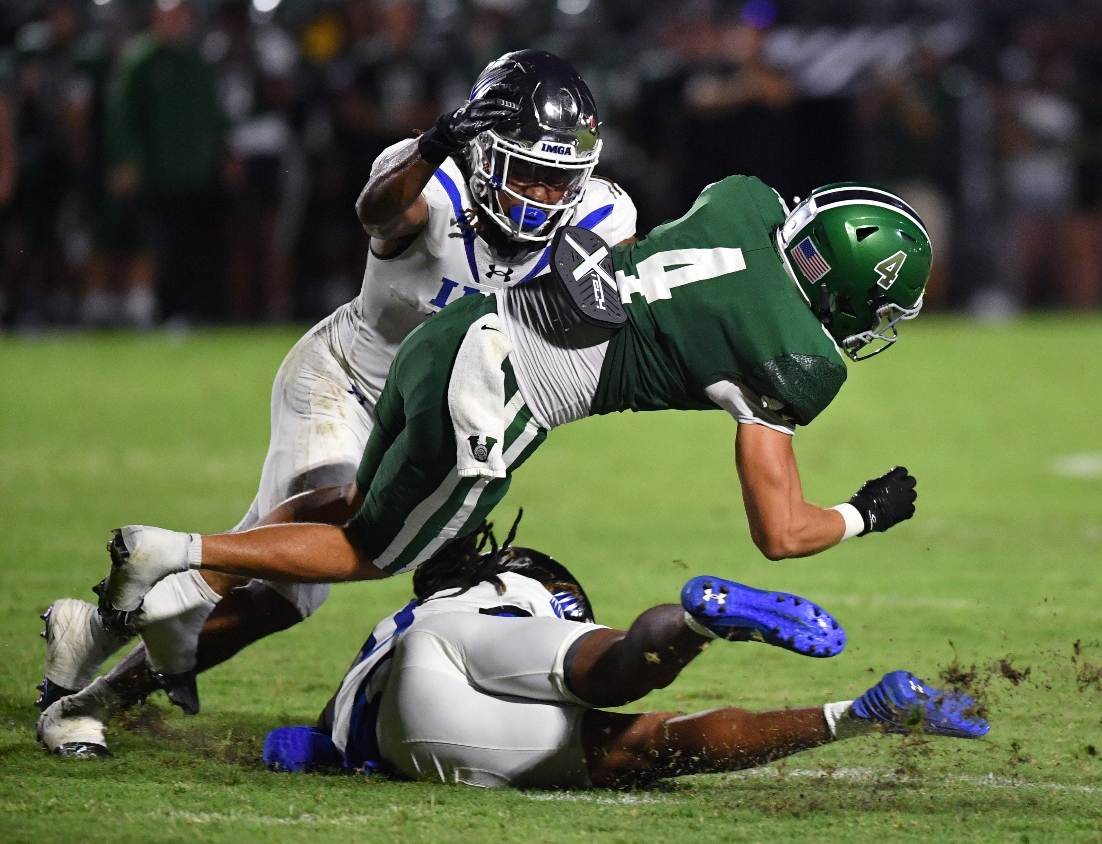 Venice High wide receiver Ryan Matulevich (#4) gets caught between IMG Academy defensive backs Zech Fort (#2, top) and Major Preston (#0, bottom). The Venice High School Indians hosted the IMG Academy Ascenders National team on Friday, Oct. 4, 2024.