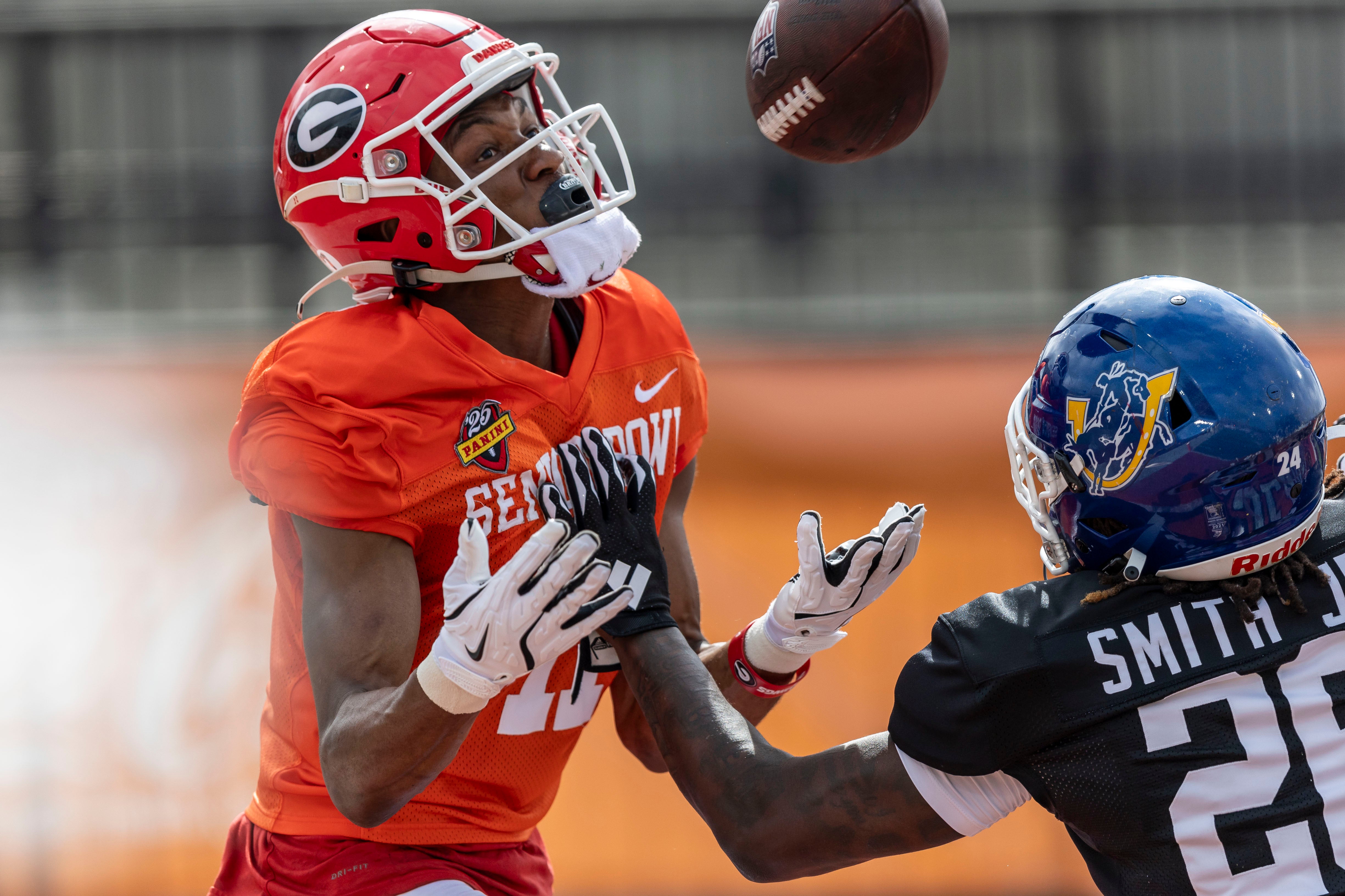 Jan 30, 2025; Mobile, AL, USA; American team wide receiver Arian Smith of Georgia (11) tracks down a pass with American team defensive back Melvin Smith Jr. of Southern Arkansas (26) defending during Senior Bowl practice for the American team at Hancock Whitney Stadium.