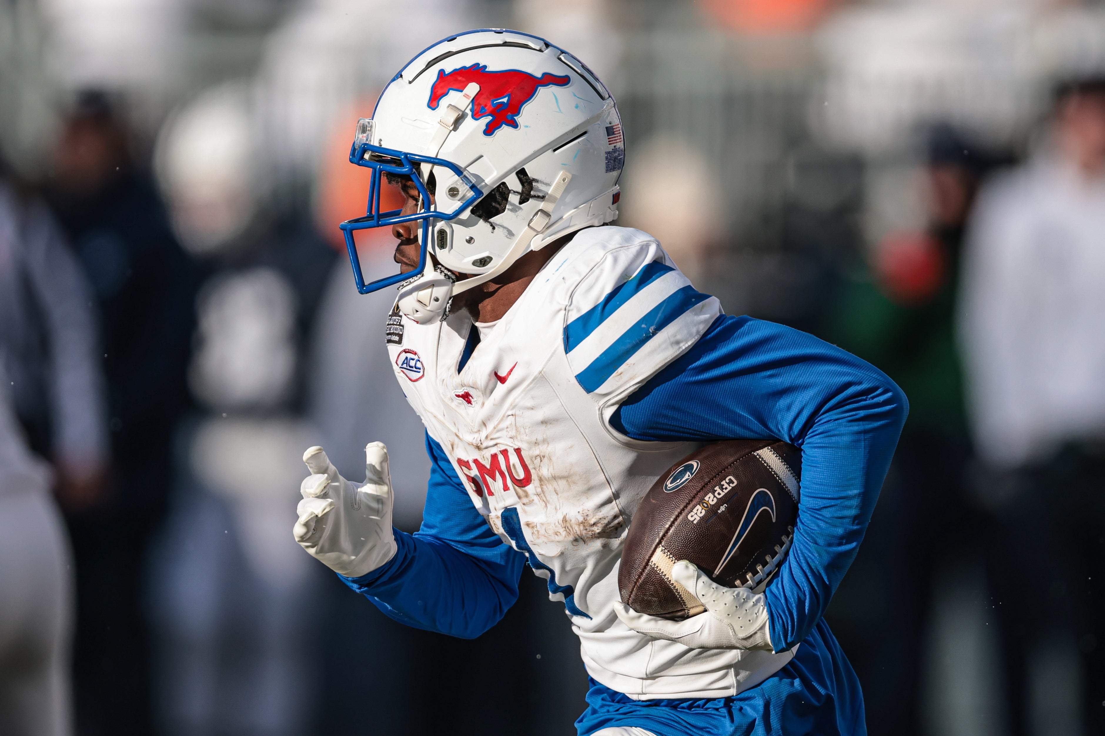 Dec 21, 2024; University Park, Pennsylvania, USA; Southern Methodist Mustangs running back Brashard Smith (1) carries the ball during the second half against the Penn State Nittany Lions at Beaver Stadium.