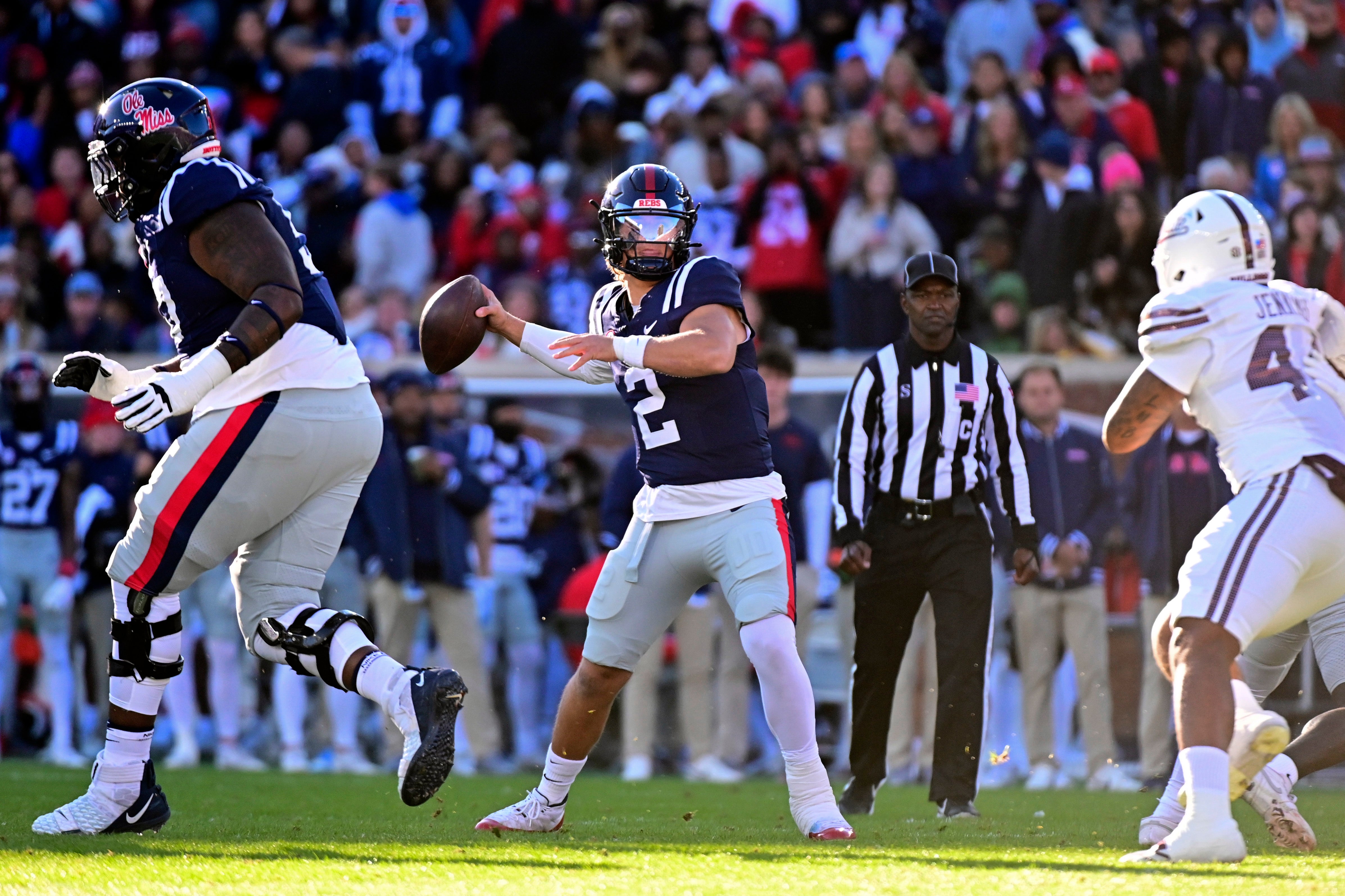 Nov 29, 2024; Oxford, Mississippi, USA; Mississippi Rebels quarterback Jaxson Dart (2) looks to pass while defended by Mississippi State Bulldogs linebacker Branden Jennings (44) during the first quarter at Vaught-Hemingway Stadium.