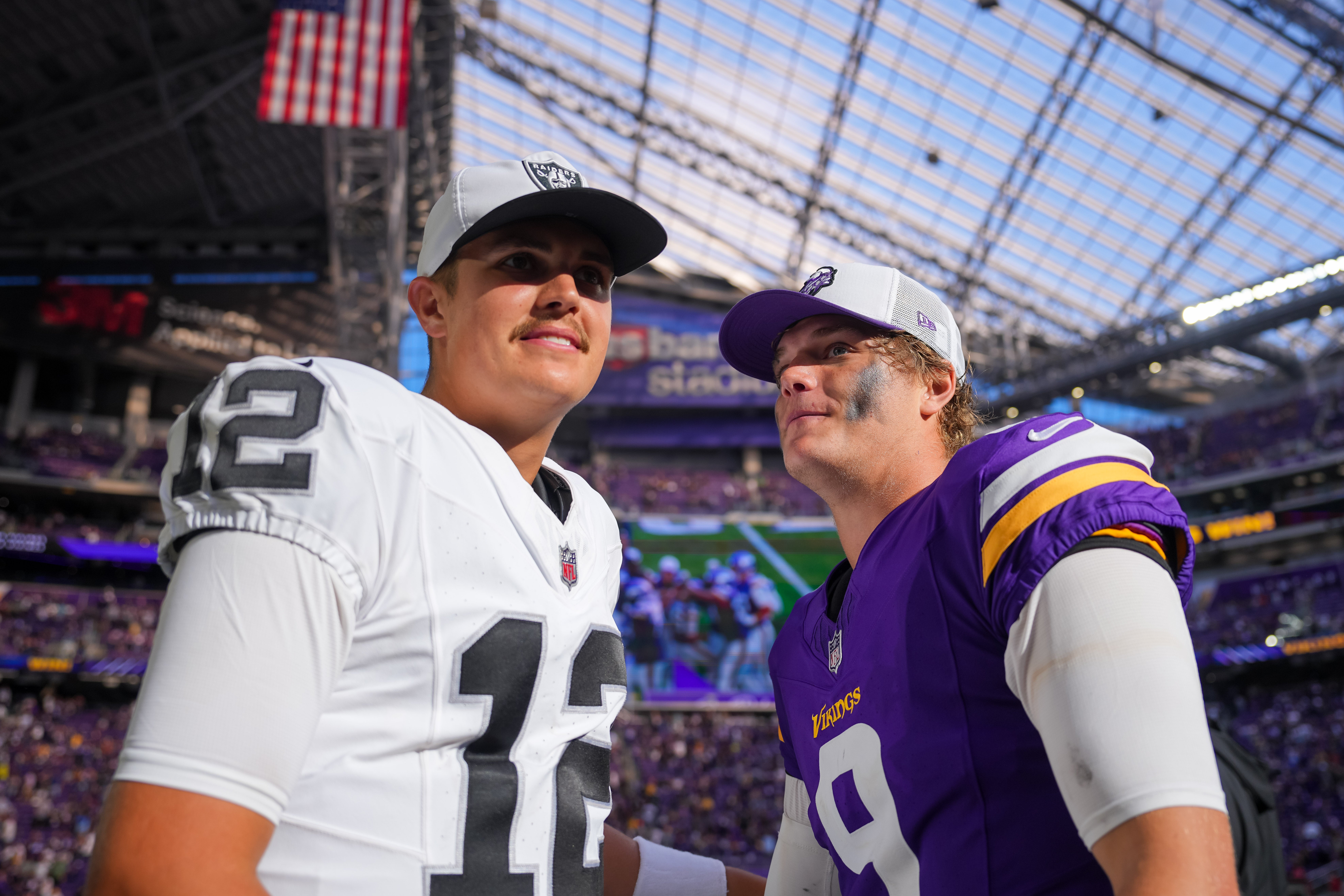 Aug 10, 2024; Minneapolis, Minnesota, USA; Minnesota Vikings quarterback J.J. McCarthy (9) and Las Vegas Raiders quarterback Aidan O'Connell (12) talk after the game at U.S. Bank Stadium.