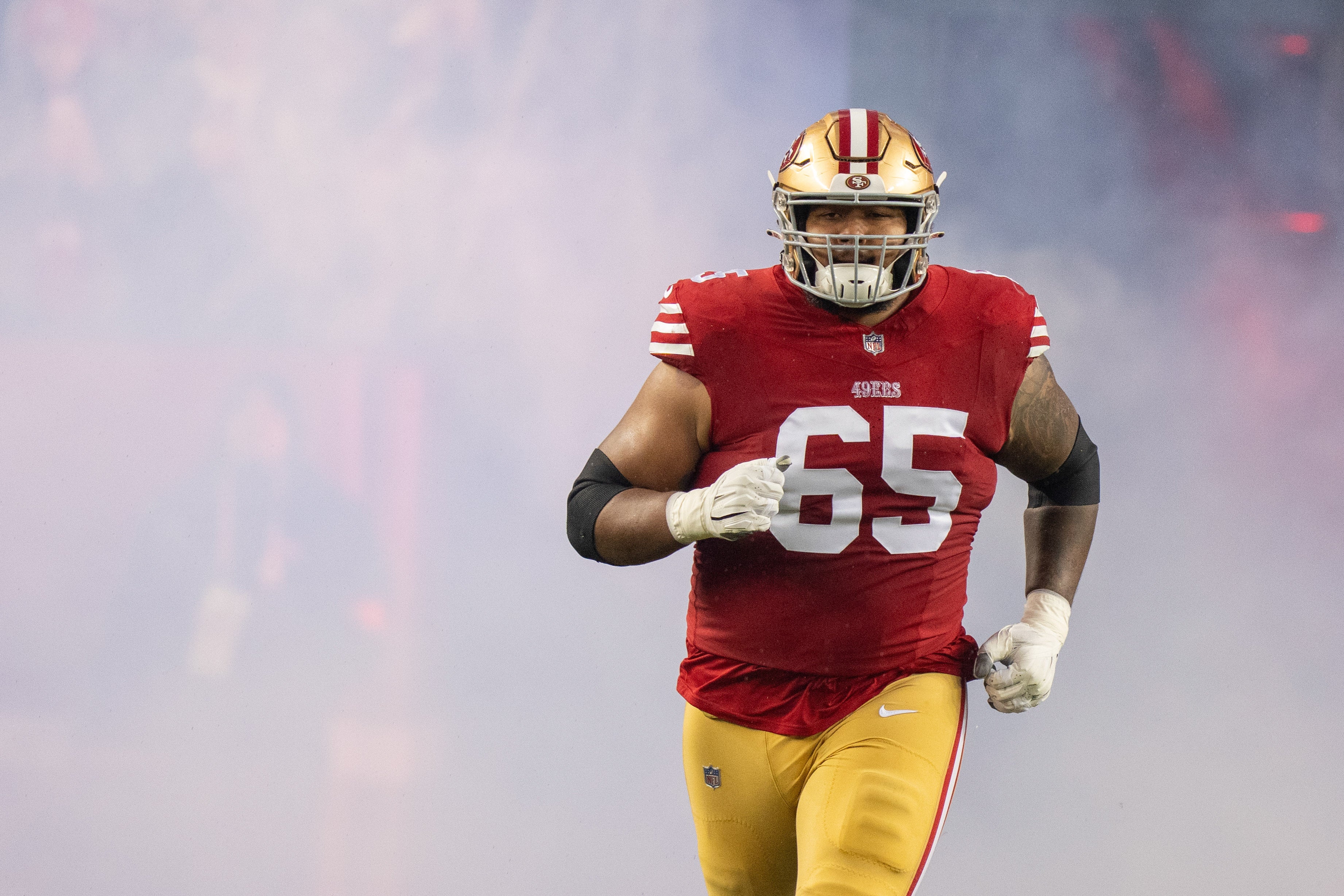 San Francisco 49ers guard Aaron Banks (65) before a 2024 NFC divisional round game against the Green Bay Packers at Levi's Stadium.