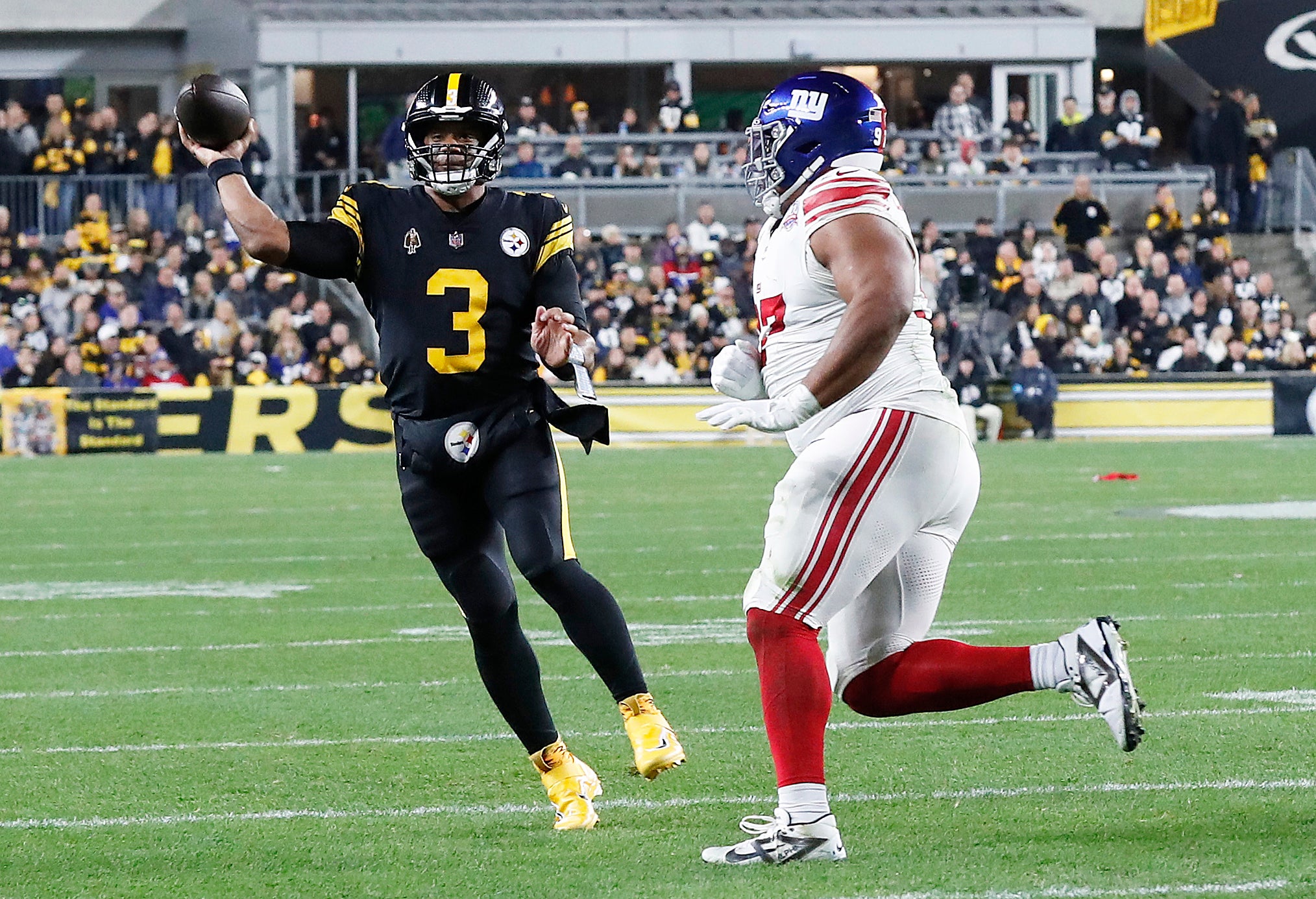 Pittsburgh Steelers quarterback Russell Wilson (3) passes against pressure from New York Giants defensive tackle Dexter Lawrence II (right) during the second quarter at Acrisure Stadium.