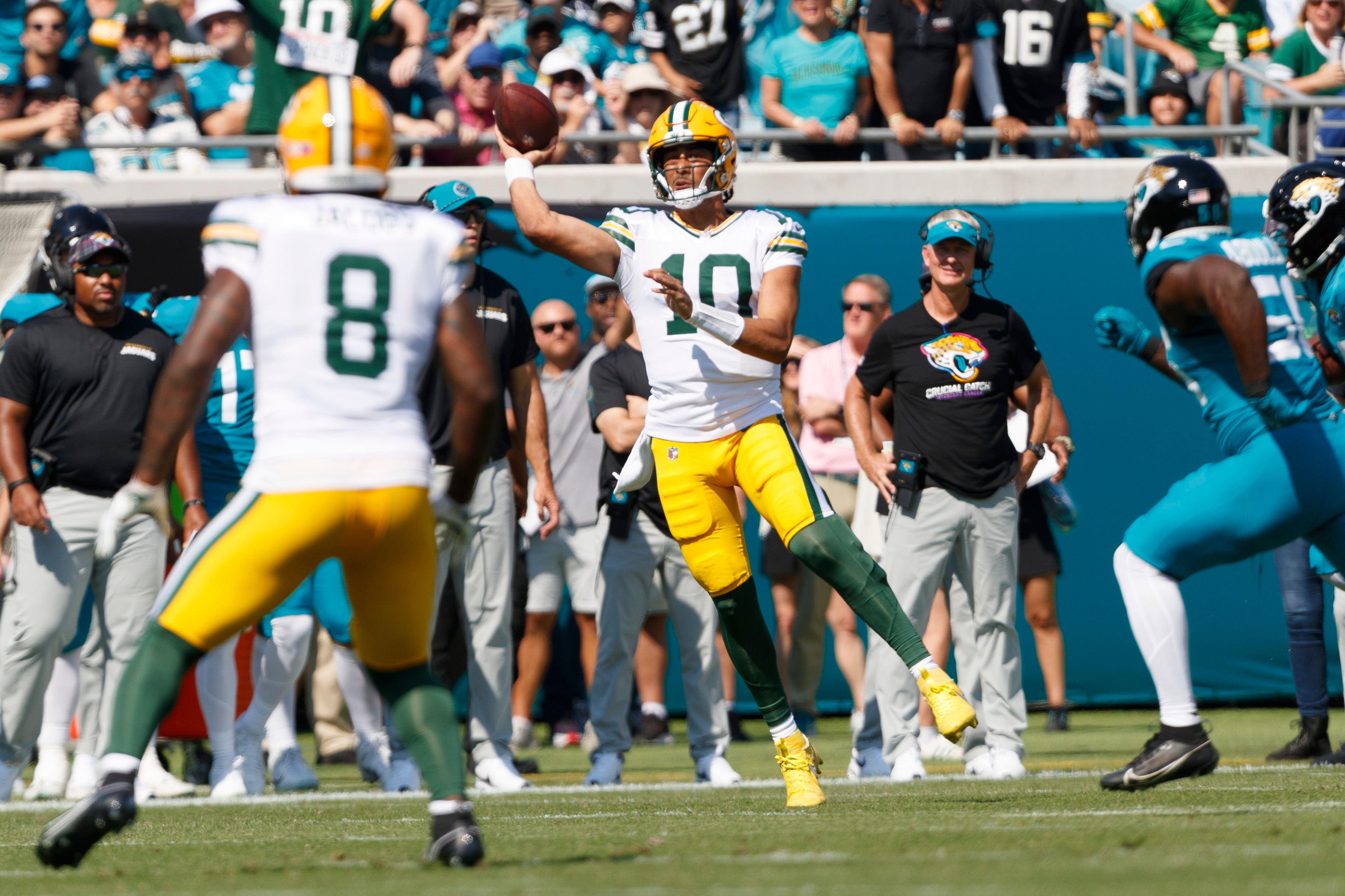 Green Bay Packers quarterback Jordan Love (10) throws a pass to running back Josh Jacobs (8) against the Jacksonville Jaguars during the first quarter at EverBank Stadium.