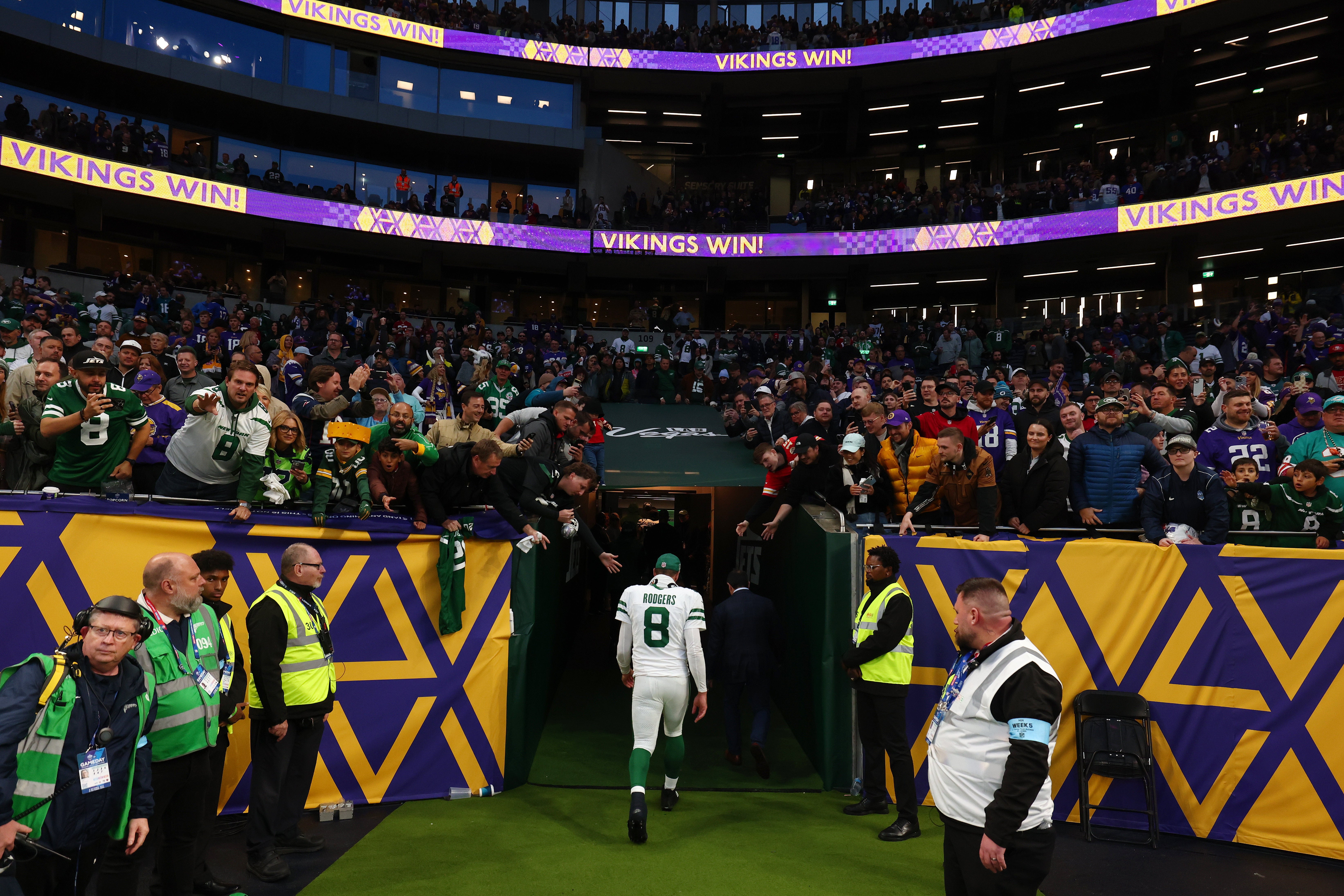 Oct 6, 2024; Tottenham, ENG; A dejected New York Jets quarterback Aaron Rodgers (8) walks back to the locker room after the 17-23 defeat to the Minnesota Vikings at Tottenham Hotspur Stadium.