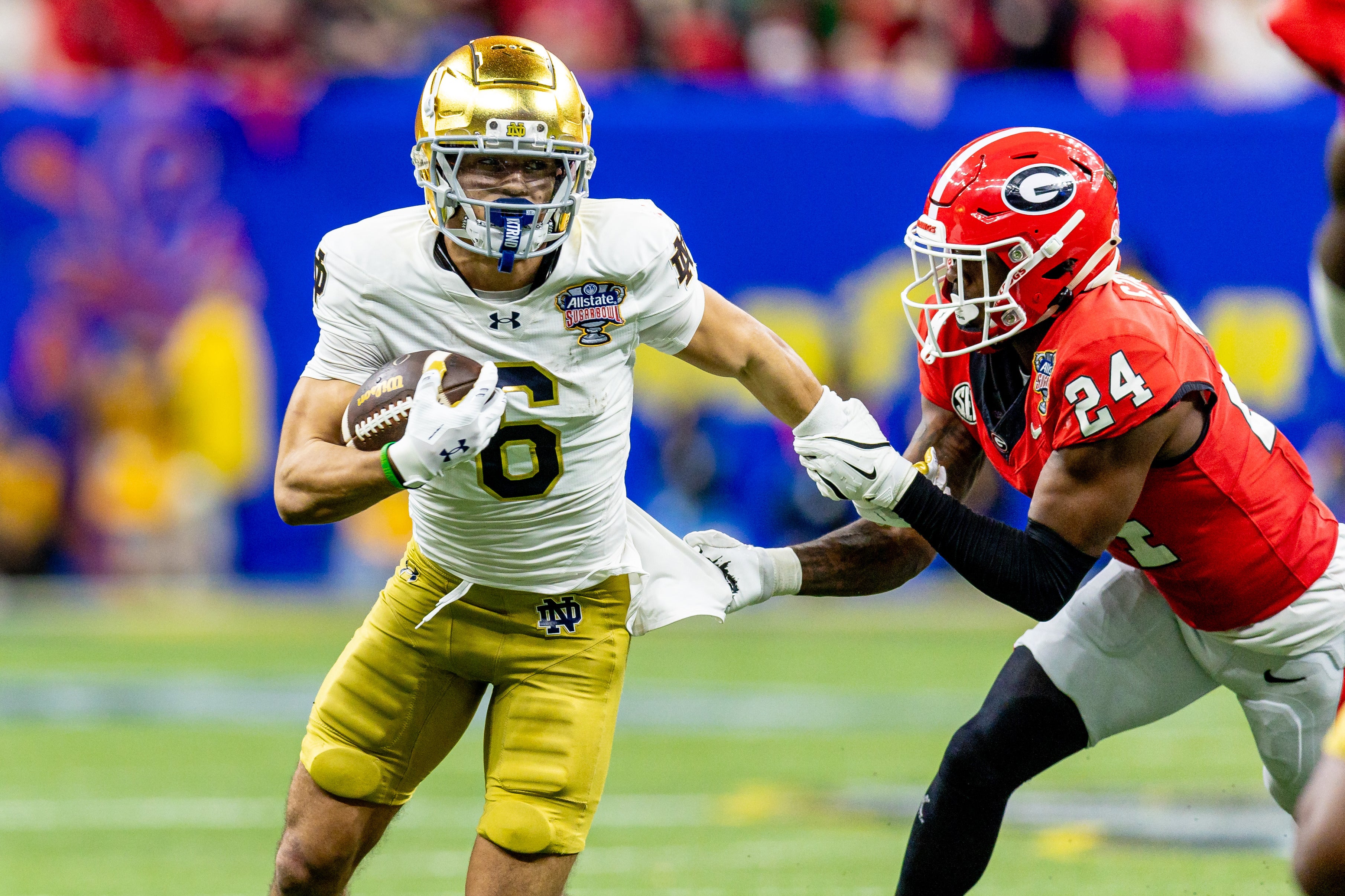 Jan 2, 2025; New Orleans, LA, USA; Notre Dame Fighting Irish wide receiver Jordan Faison (6) is tackled by Georgia Bulldogs defensive back Malaki Starks (24) during the second half at Caesars Superdome.