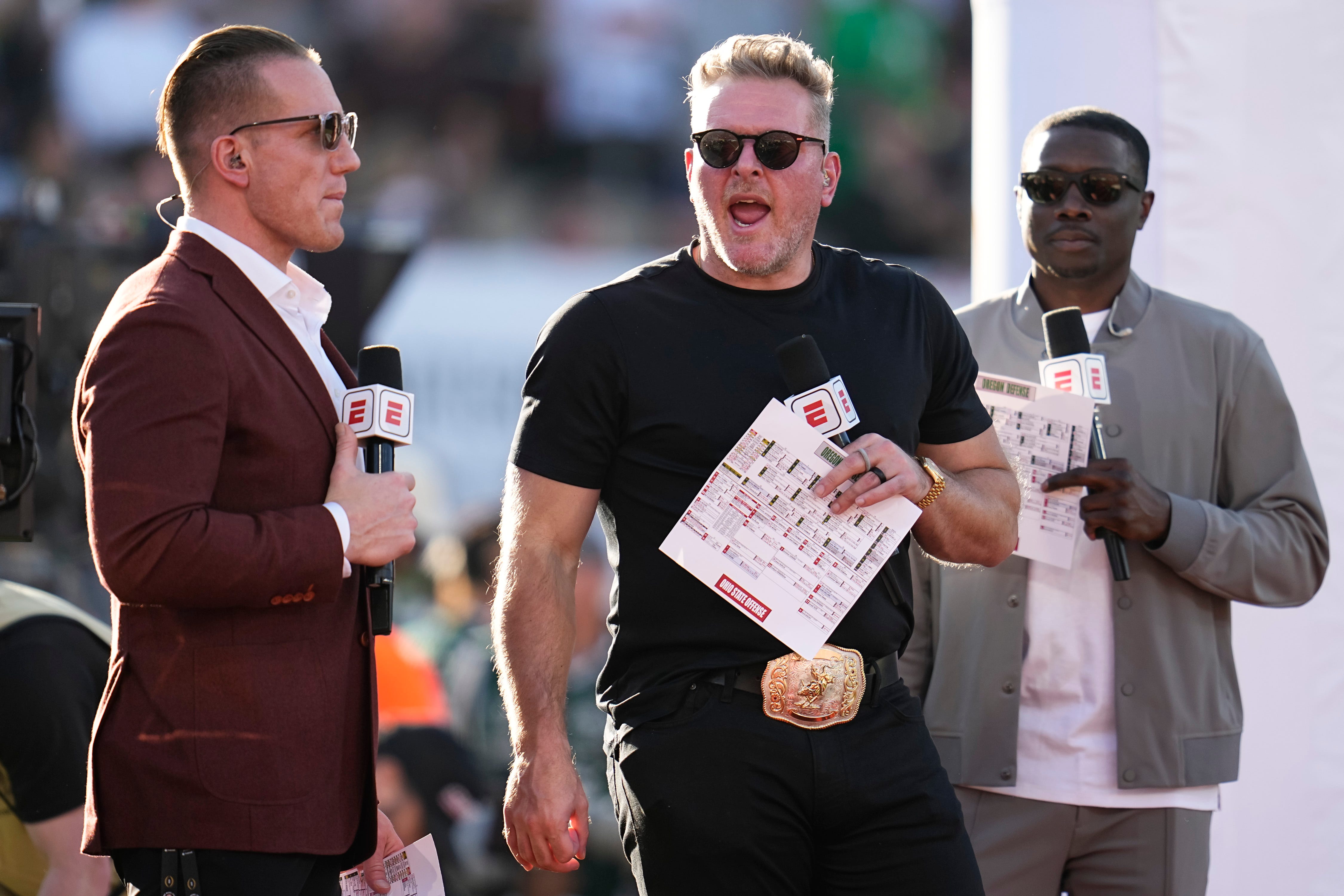 ESPN's AJ Hawk, left, and Pat McAfee broadcast from the sideline during the College Football Playoff quarterfinal between the Ohio State Buckeyes and the Oregon Ducks at the Rose Bowl in Pasadena, Calif. on Jan. 1, 2025. Ohio State won 41-21.