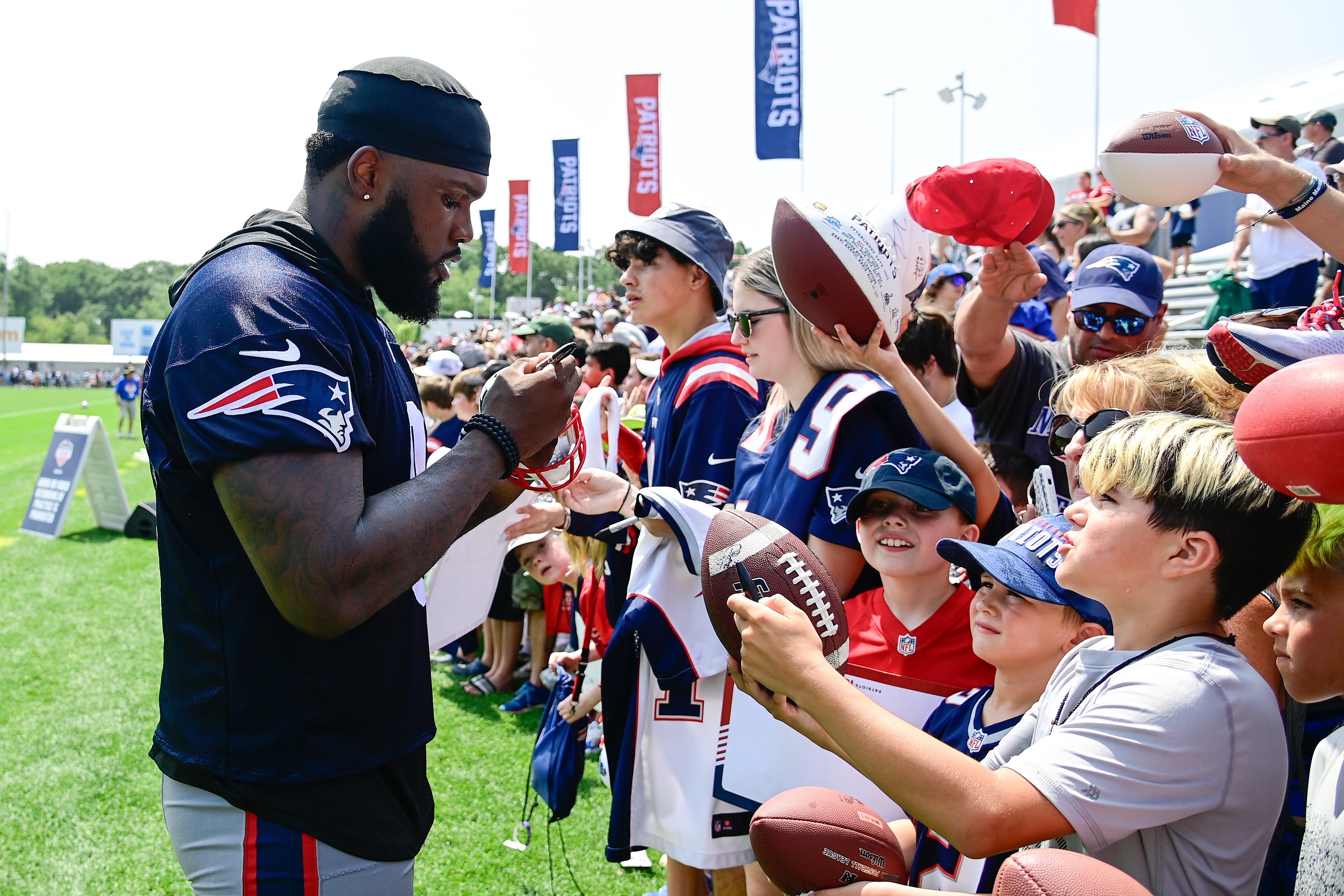 Jul 26, 2023; Foxborough, MA, USA; New England Patriots linebacker Ja'Whaun Bentley (8) signs autographs for fans at training camp at Gillette Stadium.