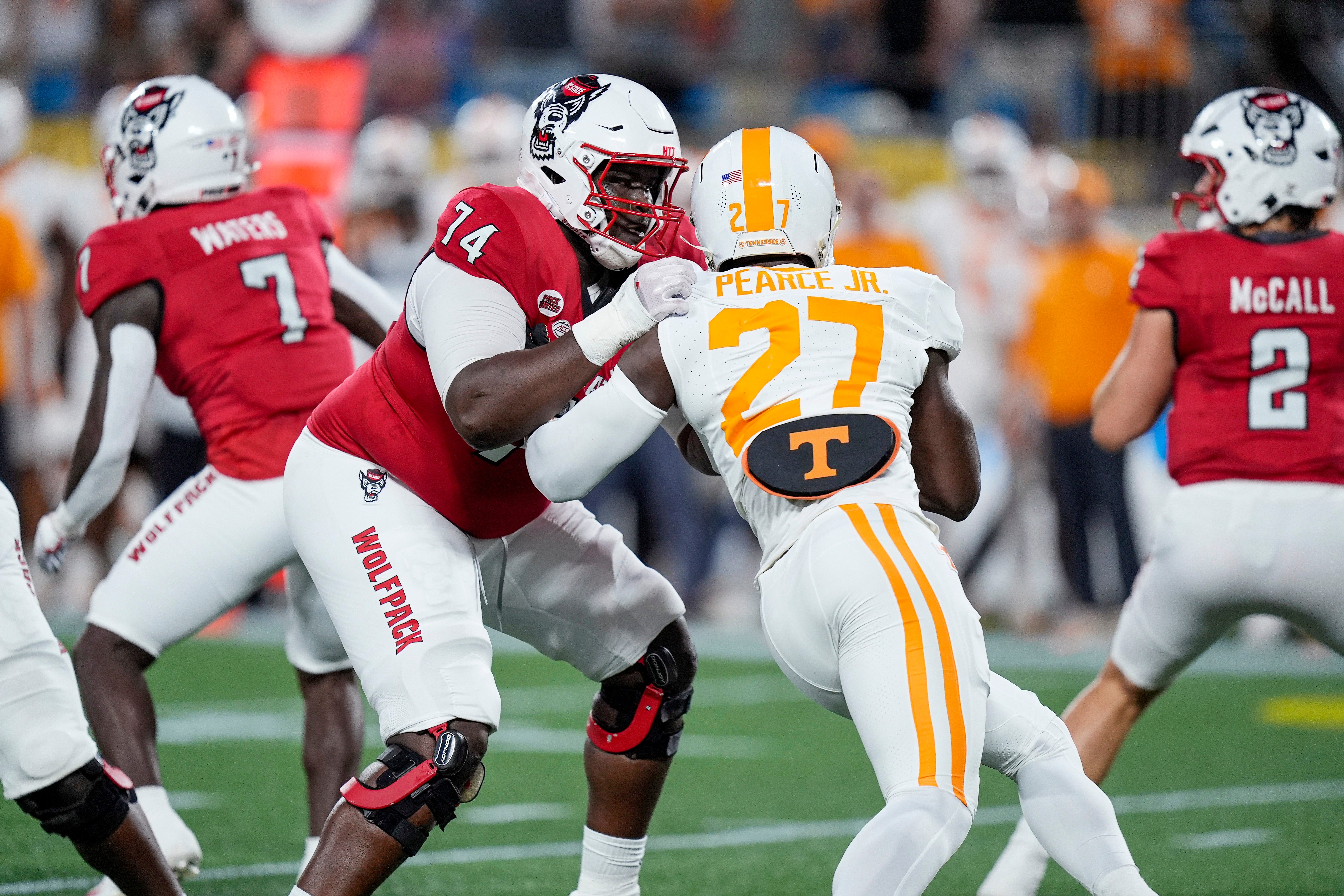 North Carolina State Wolfpack offensive tackle Anthony Belton (74) blocks Tennessee Volunteers defensive lineman James Pearce Jr. (27) during the first quarter at the Dukes Mayo Classic