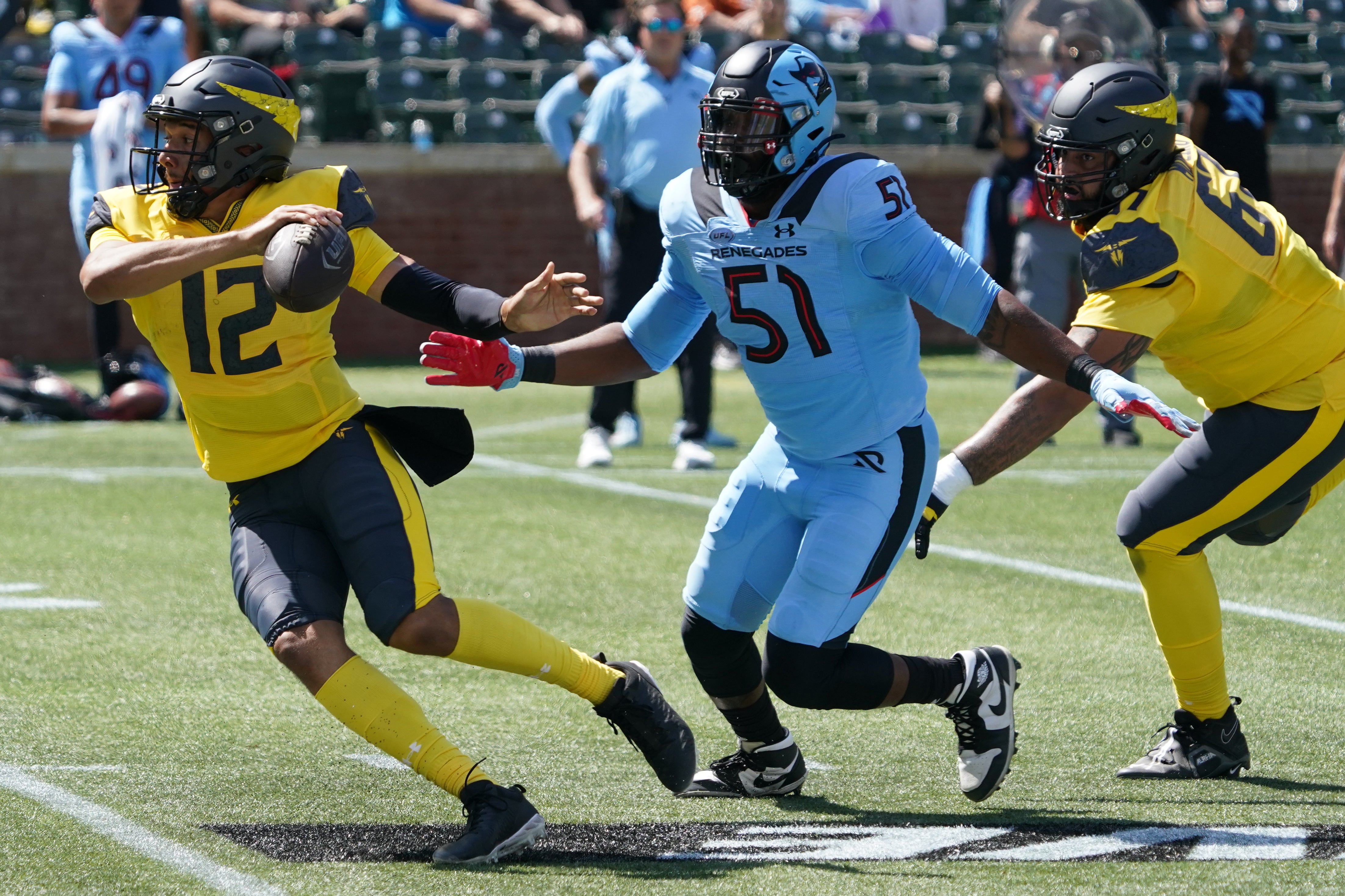 Mar 29, 2025; Arlington, TX, USA; San Antonio Brahmas quarterback Kellen Mond (12) tries to avoid the pressure by Arlington Renegades linebacker Tuzar Skipper (51) during the first half at Choctaw Stadium.