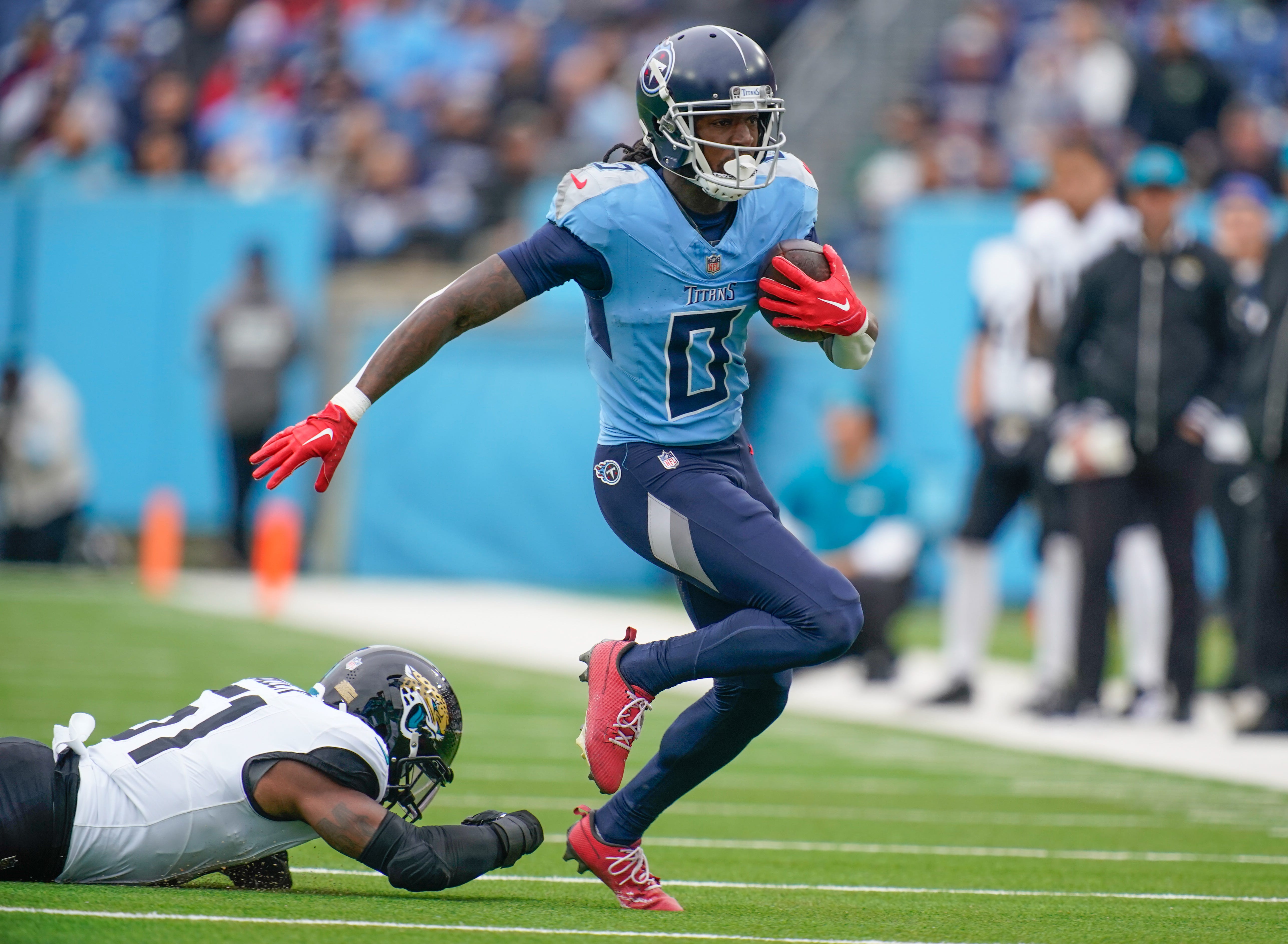 Tennessee Titans wide receiver Calvin Ridley (0) gets past Jacksonville Jaguars linebacker Ventrell Miller (51) during the first quarter at Nissan Stadium in Nashville, Tenn., Sunday, Dec. 8, 2024.