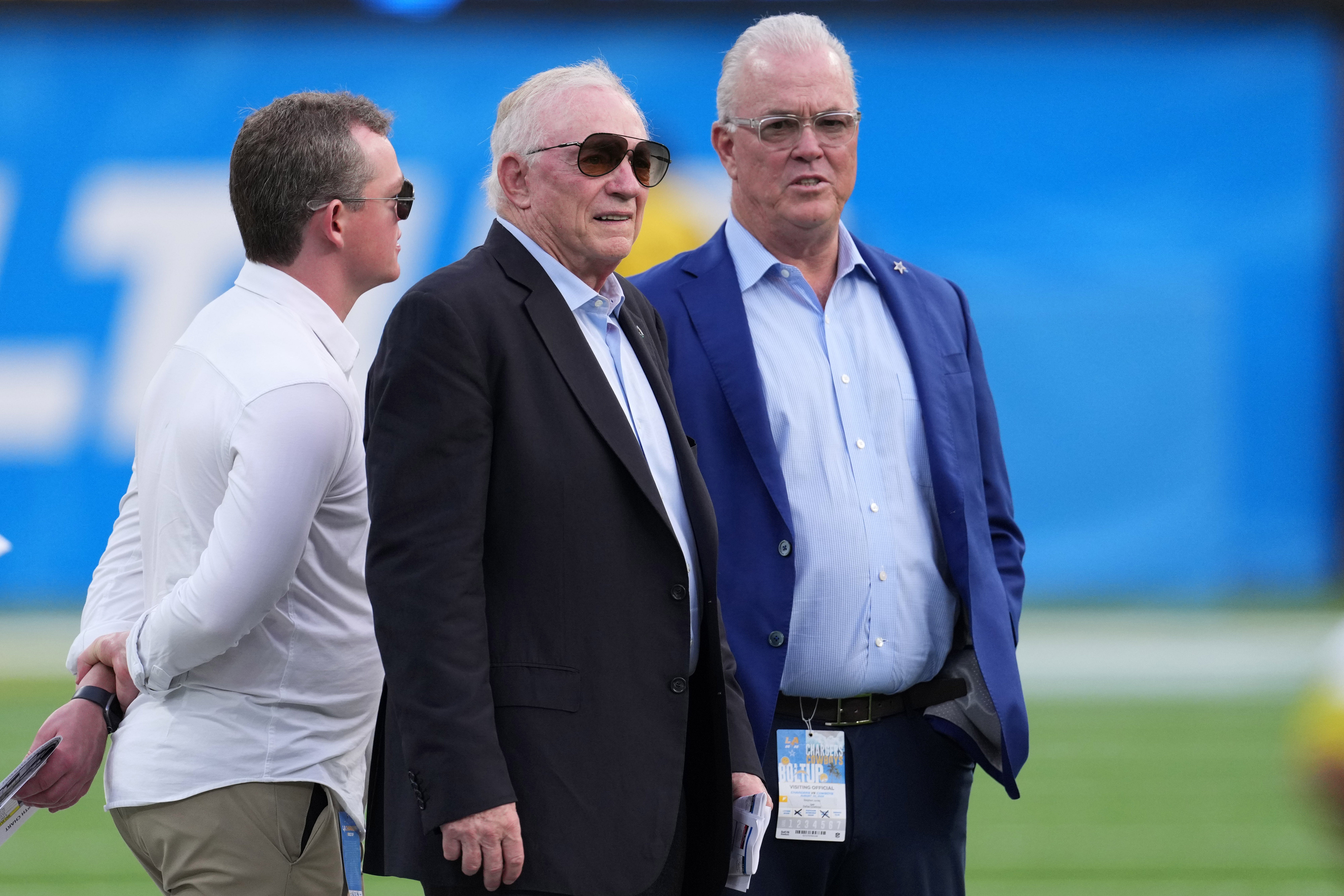 Dallas Cowboys owner Jerry Jones (center) and chief executive vice president Stephen Jones react before the game against the Los Angeles Chargers at SoFi Stadium.