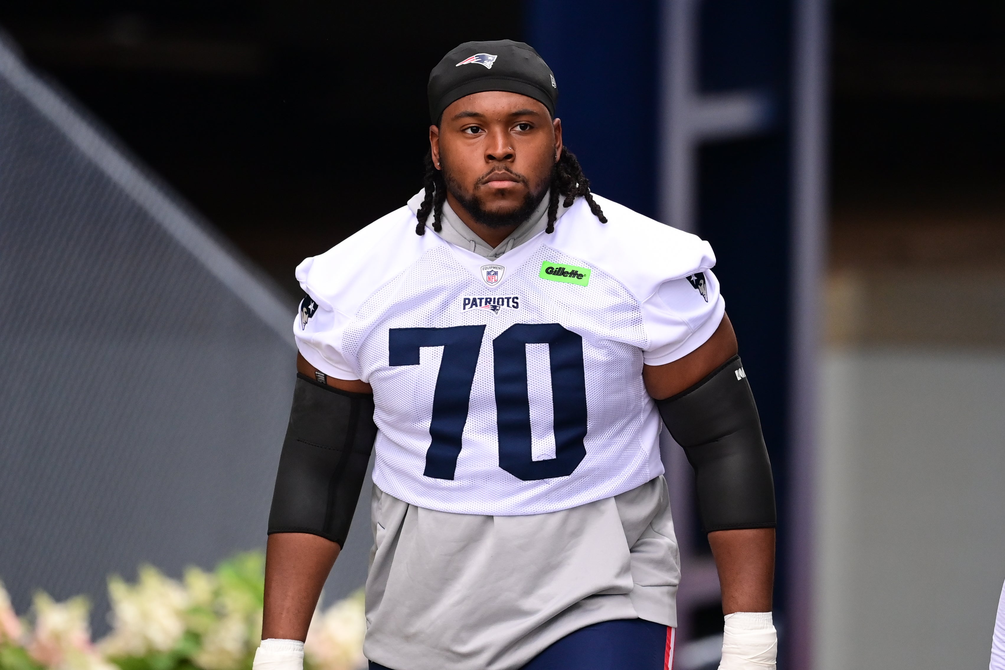 Jul 24, 2024; Foxborough, MA, USA; New England Patriots offensive tackle Caedan Wallace (70) walks to the practice field during training camp at Gillette Stadium.