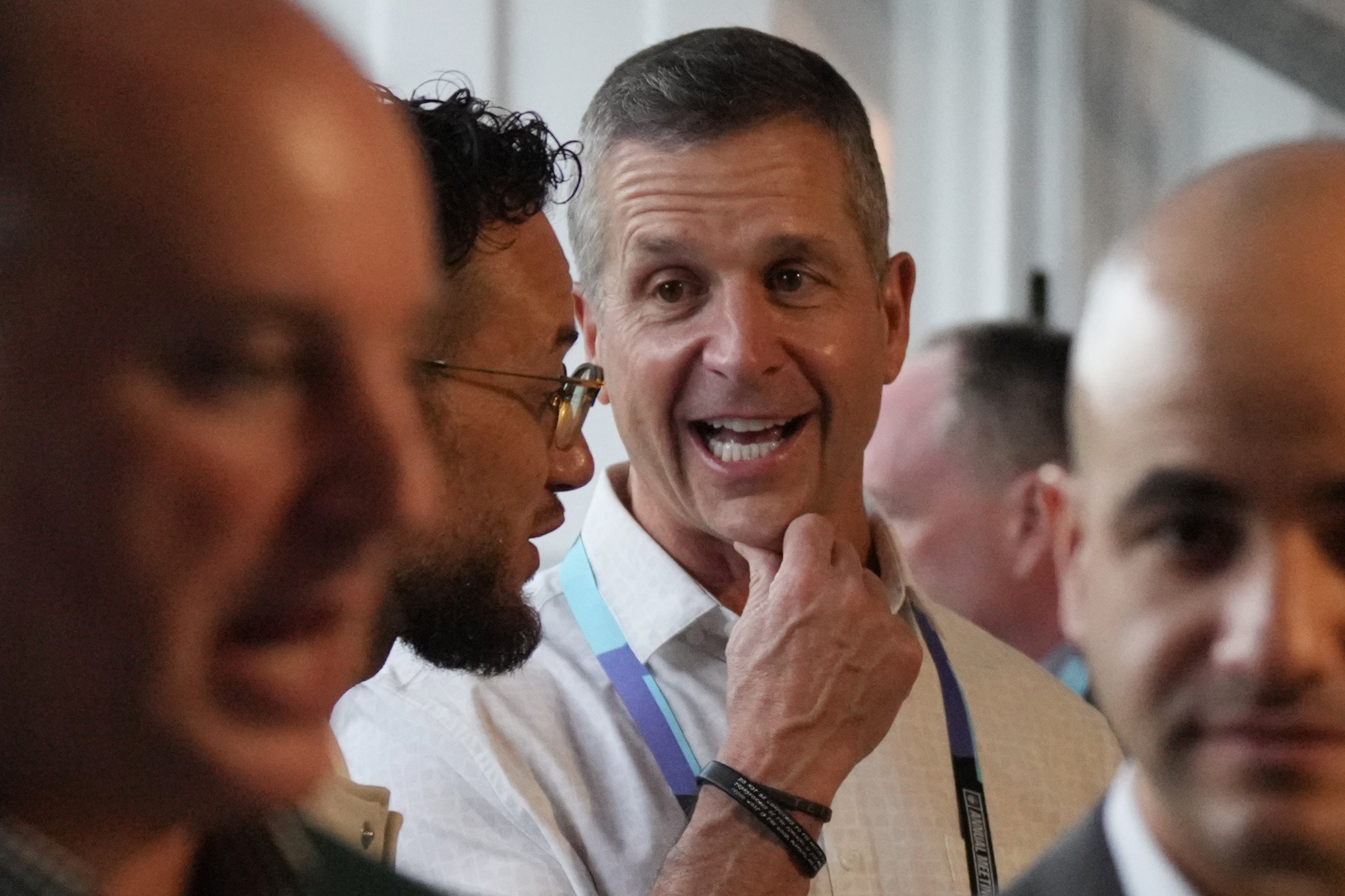 Mar 31, 2025; Palm Beach, FL, USA; Miami Dolphins head coach Mike McDaniel, center left, and Baltimore Ravens head coach John Harbaugh, center, attend the NFL Annual League Meeting at The Breakers.