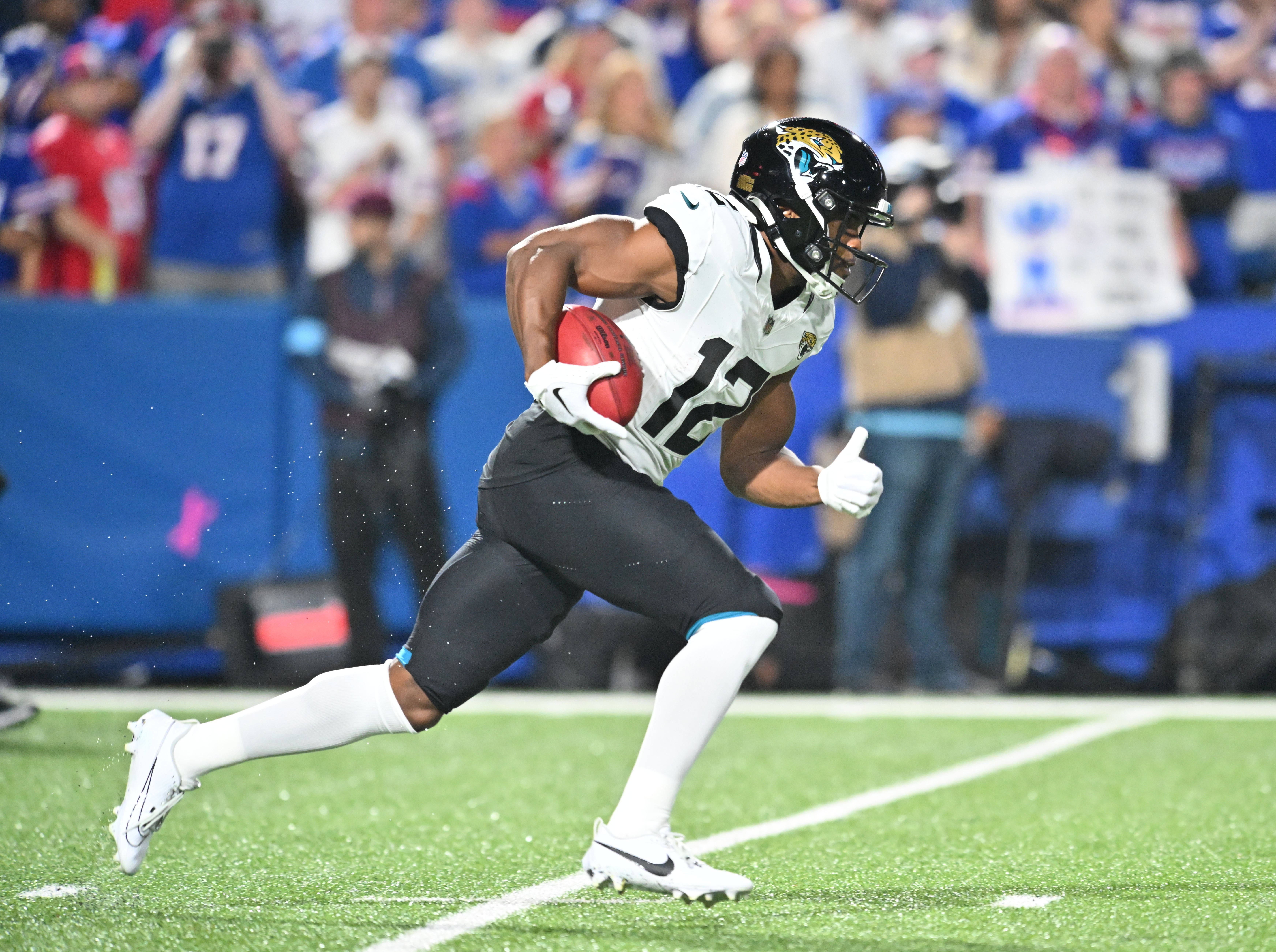 Sep 23, 2024; Orchard Park, New York, USA; Jacksonville Jaguars wide receiver Devin Duvernay (12) returns a kickoff in the first quarter against the Buffalo Bills at Highmark Stadium.