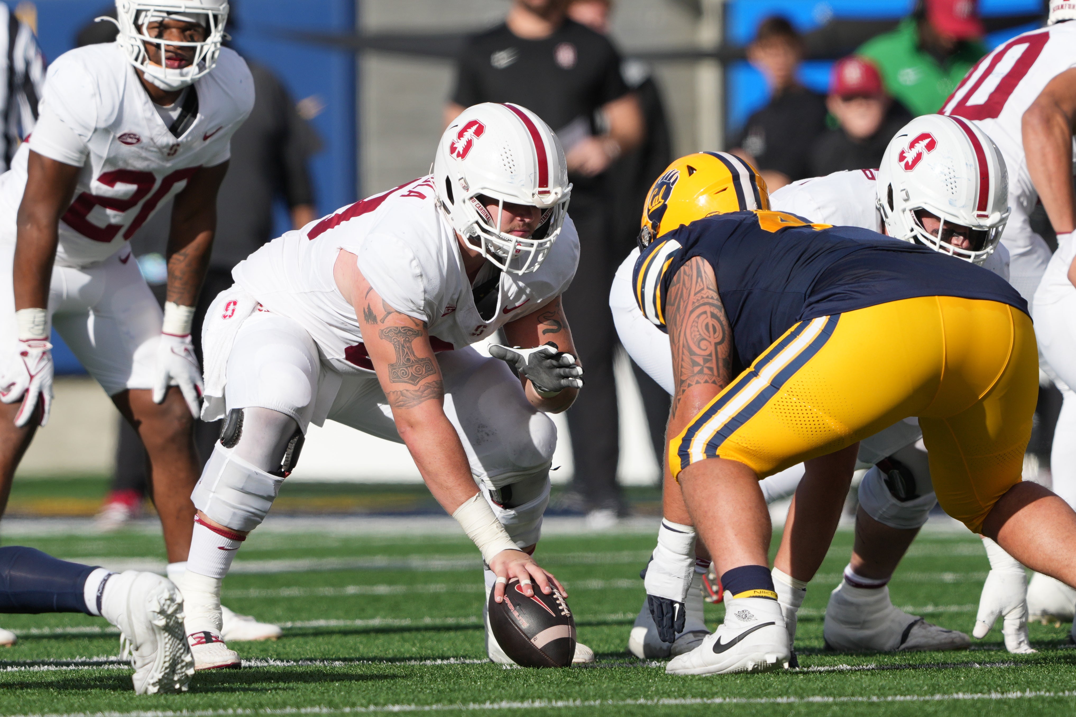 Nov 23, 2024; Berkeley, California, USA; Stanford Cardinal offensive lineman Jake Maikkula (center left)) lines up against California Golden Bears defensive lineman Aidan Keanaaina (right) during the second quarter at California Memorial Stadium.