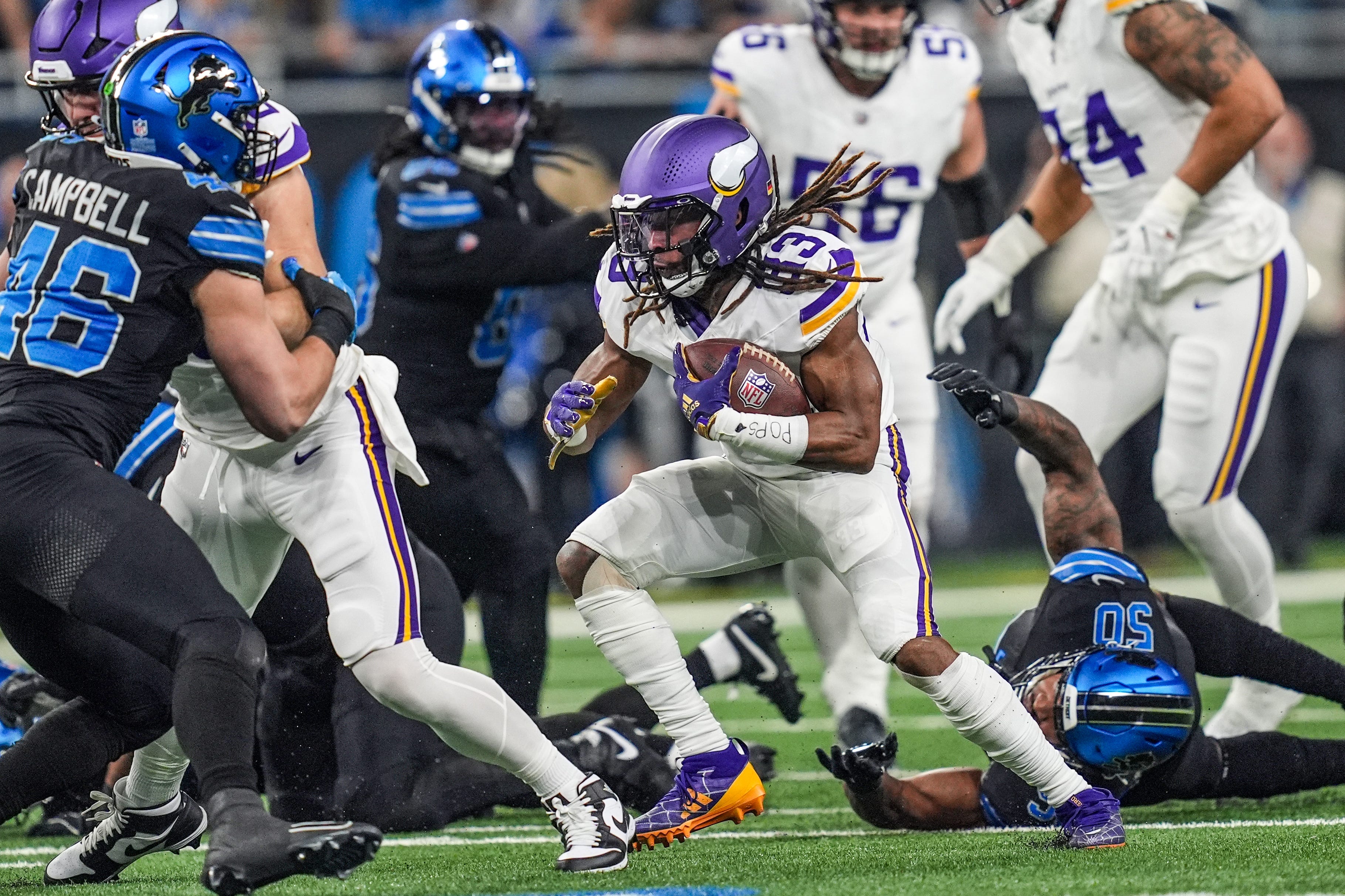 Minnesota Vikings running back Aaron Jones (33) runs for yards during the first half of the NFL game at Ford Field in Detroit on Sunday, Jan. 5, 2025.