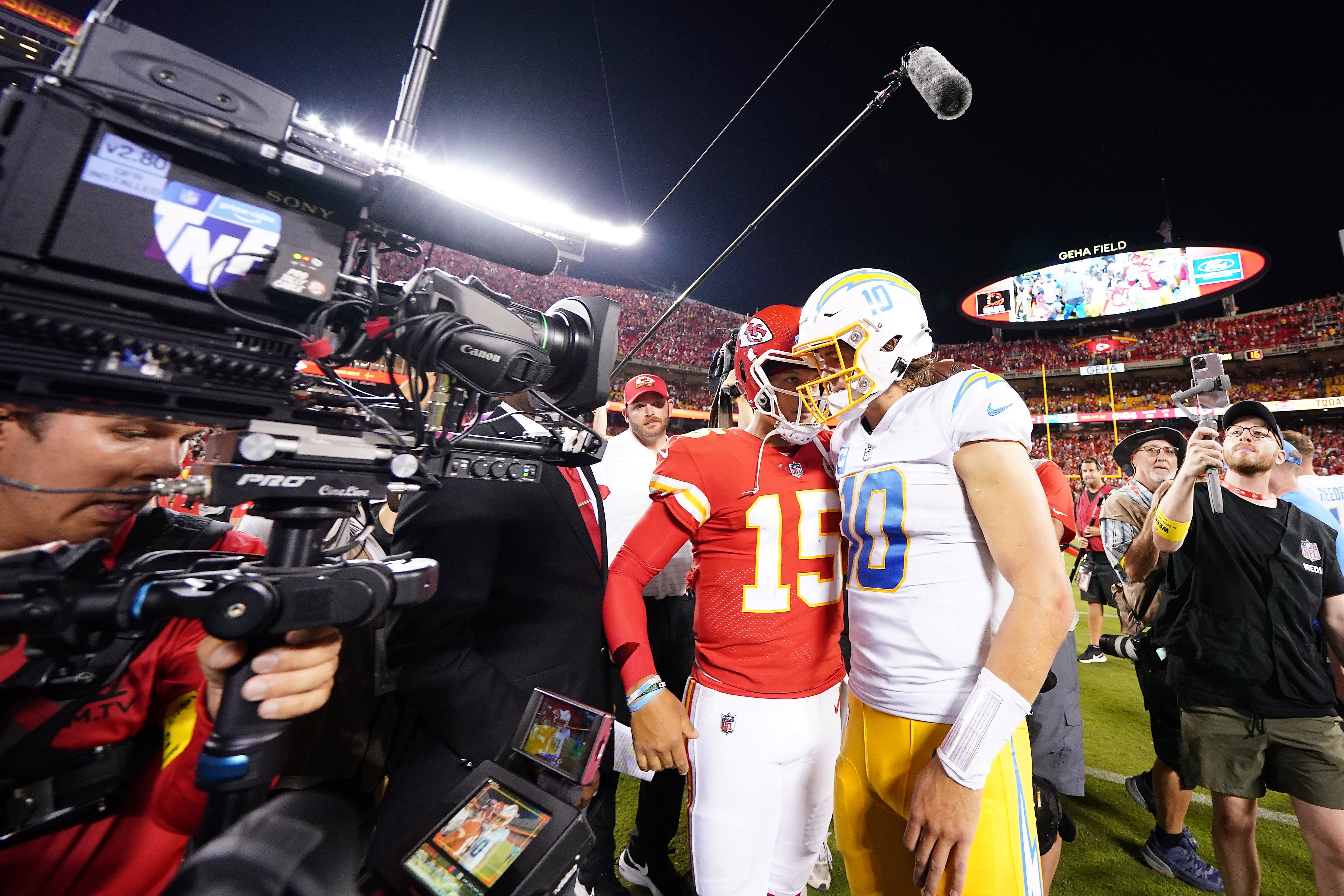 Los Angeles Chargers quarterback Justin Herbert (10) meets with Kansas City Chiefs quarterback Patrick Mahomes (15) following the game at GEHA Field at Arrowhead Stadium.